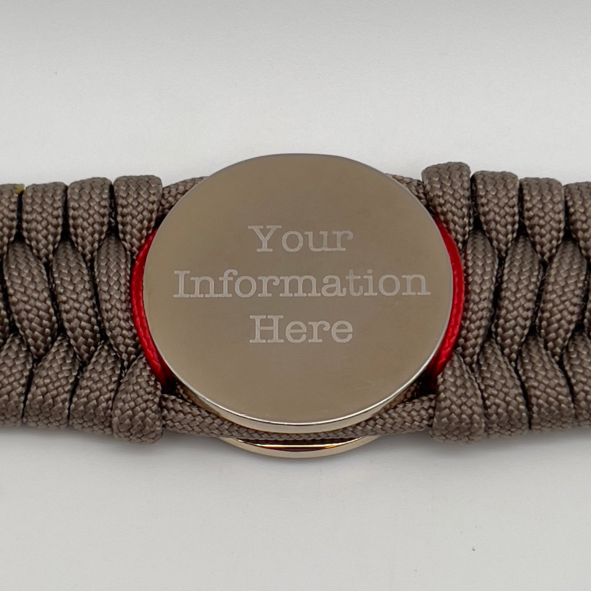 Thick, semi-rigid and comfortable braided United States Marine Corps bracelet featuring a 24K gold and silver plated USMC officer Eagle Globe and Anchor medallion, a gold Cobra style tactical buckle and woven with tan 550 paracord and Imperial Red micro cord.