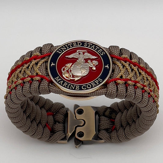 Thick, semi-rigid and comfortable braided United States Marine Corps bracelet featuring a 24K gold and silver plated USMC officer Eagle Globe and Anchor medallion, a gold Cobra style tactical buckle and woven with tan 550 paracord and Imperial Red and gold micro cord.