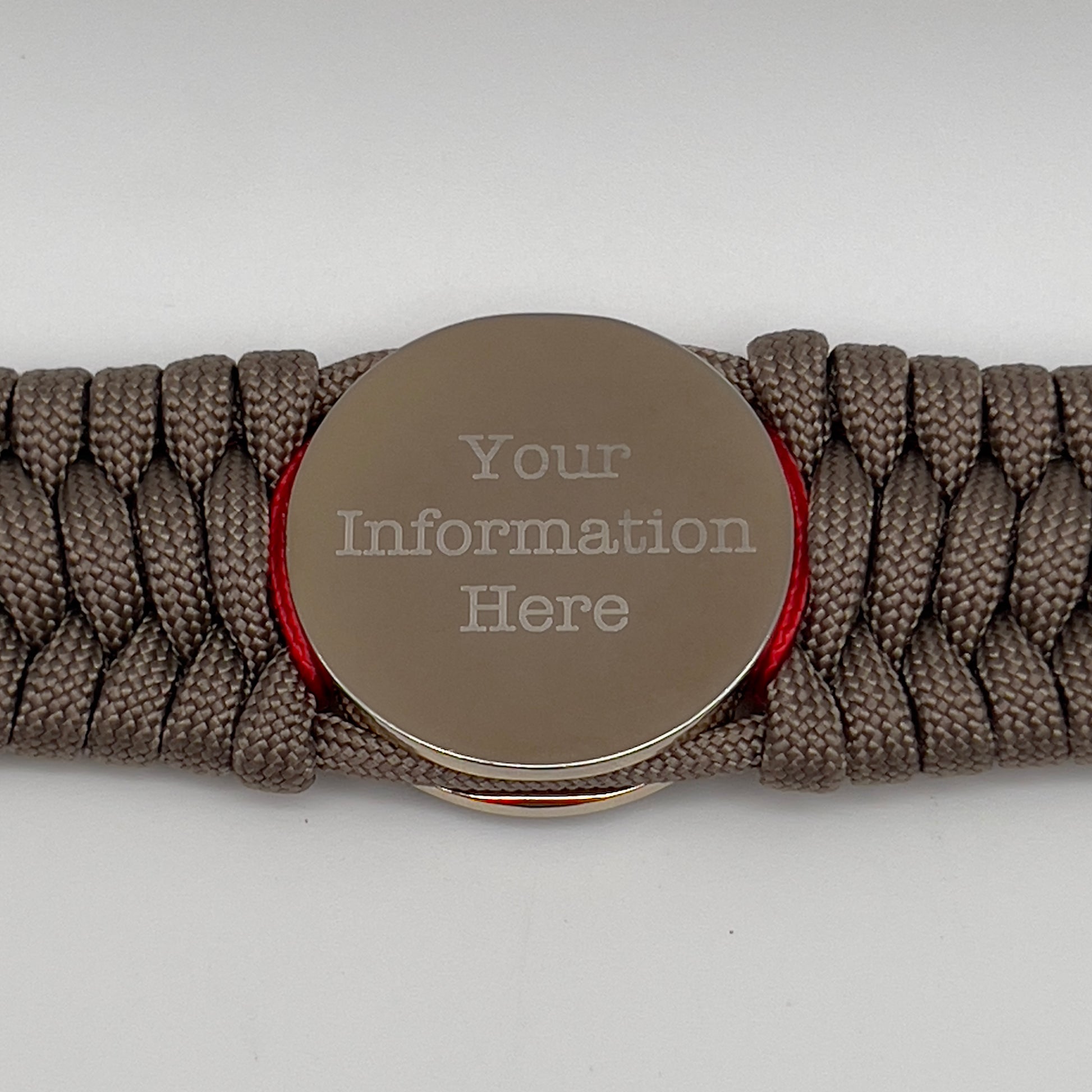 Thick, semi-rigid and comfortable braided United States Marine Corps bracelet featuring a 24K gold and silver plated USMC officer Eagle Globe and Anchor medallion, a gold Cobra style tactical buckle and woven with tan 550 paracord and Imperial Red and gold micro cord.