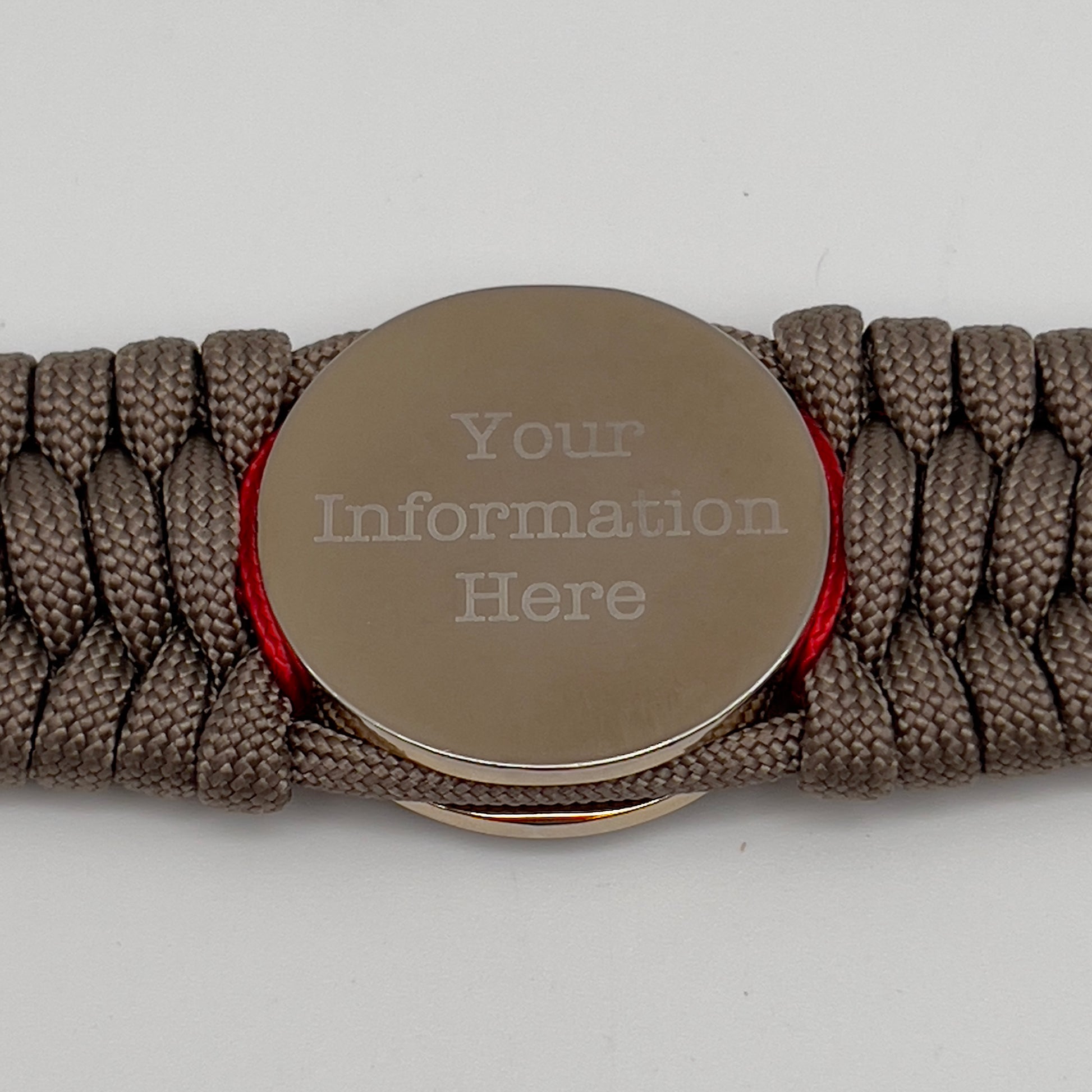 Thick, semi-rigid and comfortable braided United States Marine Corps bracelet featuring a 24K gold and silver plated USMC officer Eagle Globe and Anchor medallion, a gold Cobra style tactical buckle and woven with tan 550 paracord and Imperial red micro cord.
