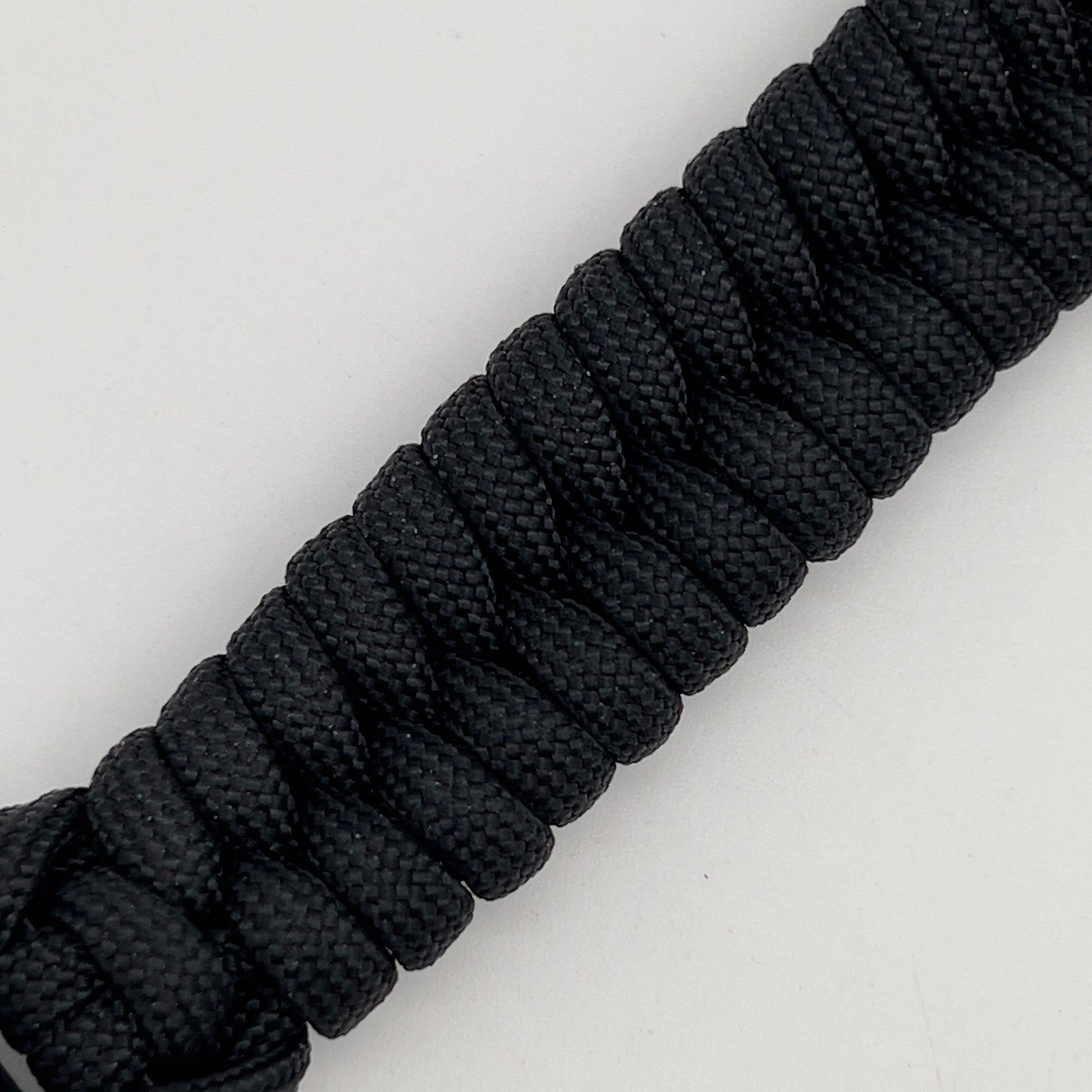 Thick, semi-rigid and comfortable braided United States Marine Corps bracelet featuring a 24K gold plated USMC officer Eagle Globe and Anchor medallion, a black Cobra style tactical buckle and woven with black 550 paracord.