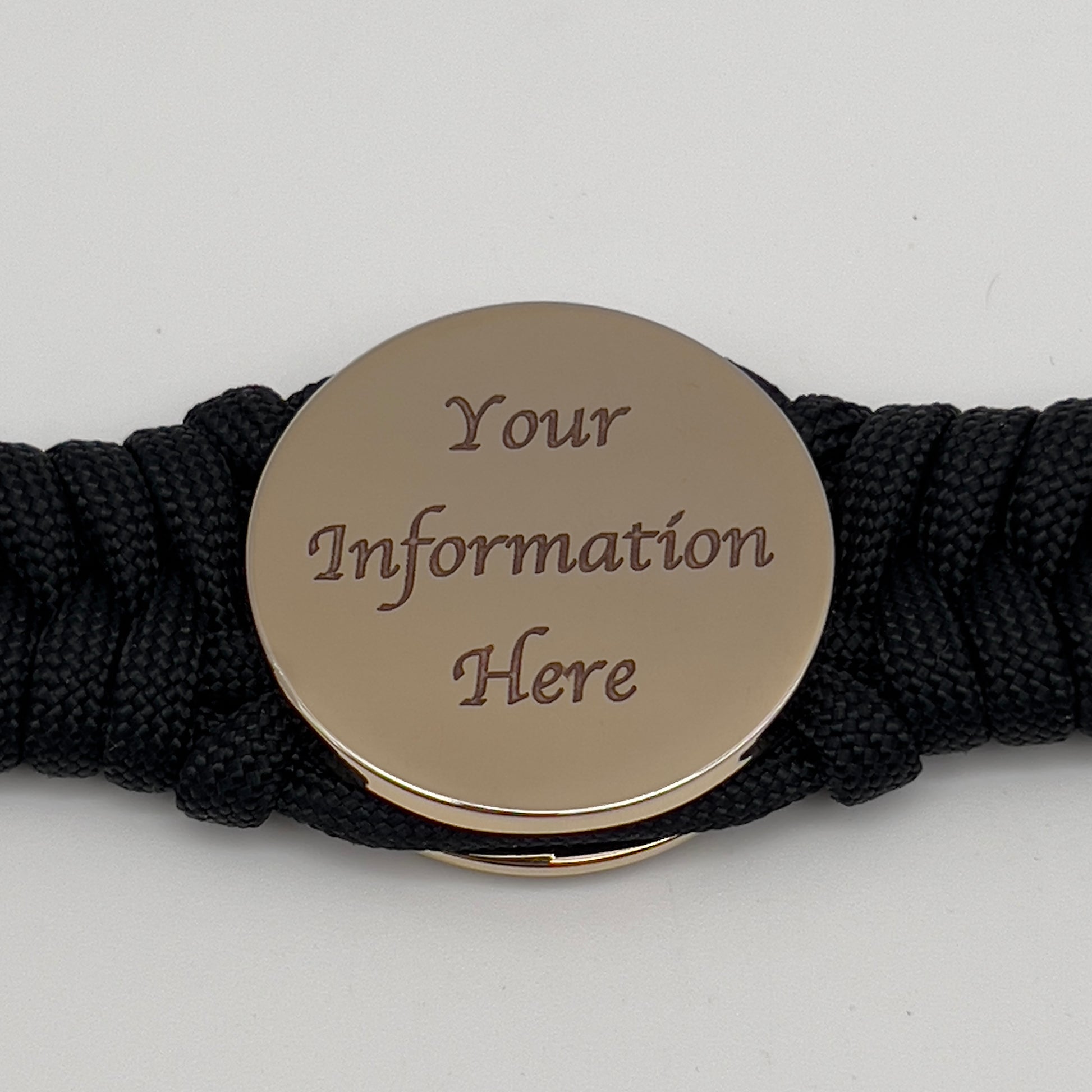 Thick, semi-rigid and comfortable braided United States Marine Corps bracelet featuring a 24K gold plated USMC officer Eagle Globe and Anchor medallion, a black Cobra style tactical buckle and woven with black 550 paracord.