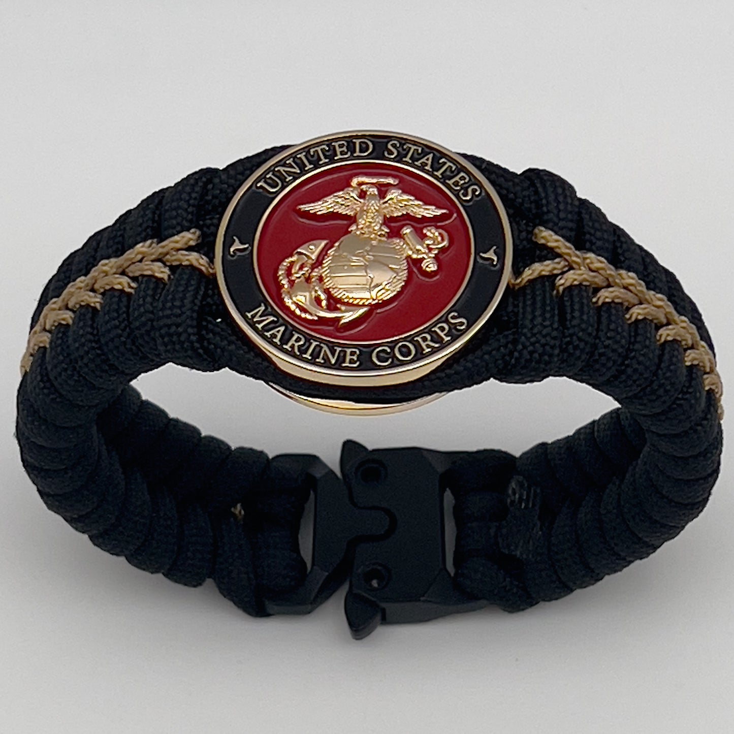 Thick, semi-rigid and comfortable braided United States Marine Corps bracelet featuring a 24K gold plated USMC officer Eagle Globe and Anchor medallion, a black Cobra style tactical buckle and woven with black 550 paracord and gold micro cord.