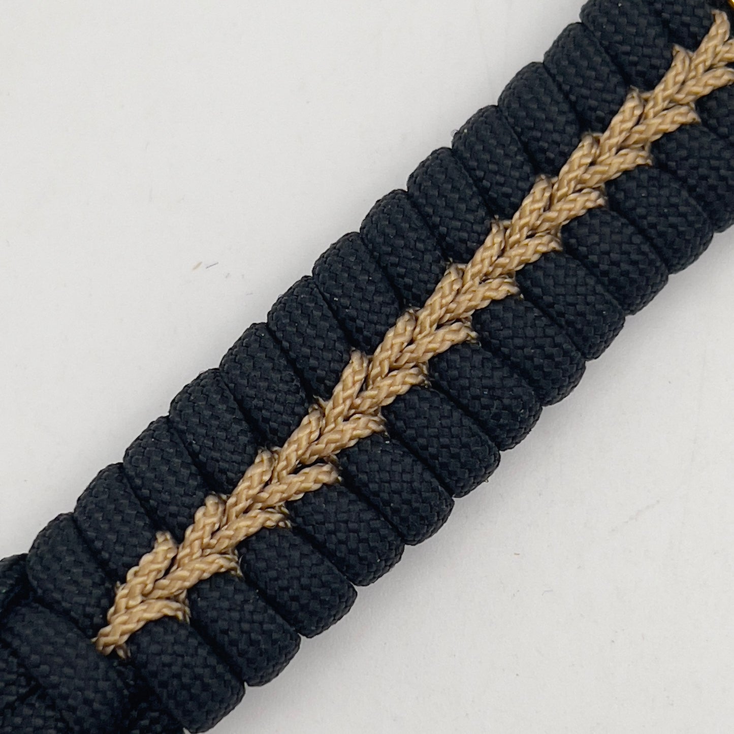 Thick, semi-rigid and comfortable braided United States Marine Corps bracelet featuring a 24K gold plated USMC officer Eagle Globe and Anchor medallion, a black Cobra style tactical buckle and woven with black 550 paracord and gold micro cord.
