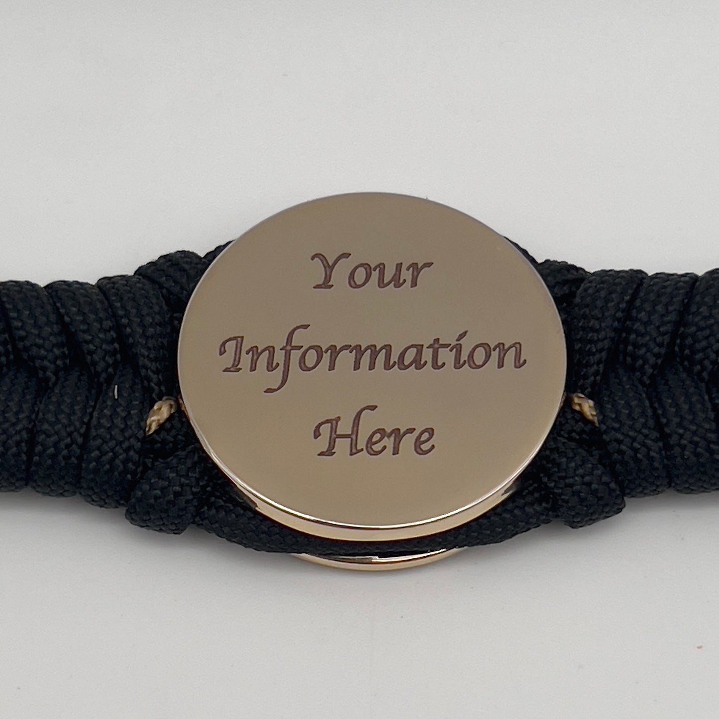 Thick, semi-rigid and comfortable braided United States Marine Corps bracelet featuring a 24K gold plated USMC officer Eagle Globe and Anchor medallion, a black Cobra style tactical buckle and woven with black 550 paracord and gold micro cord.