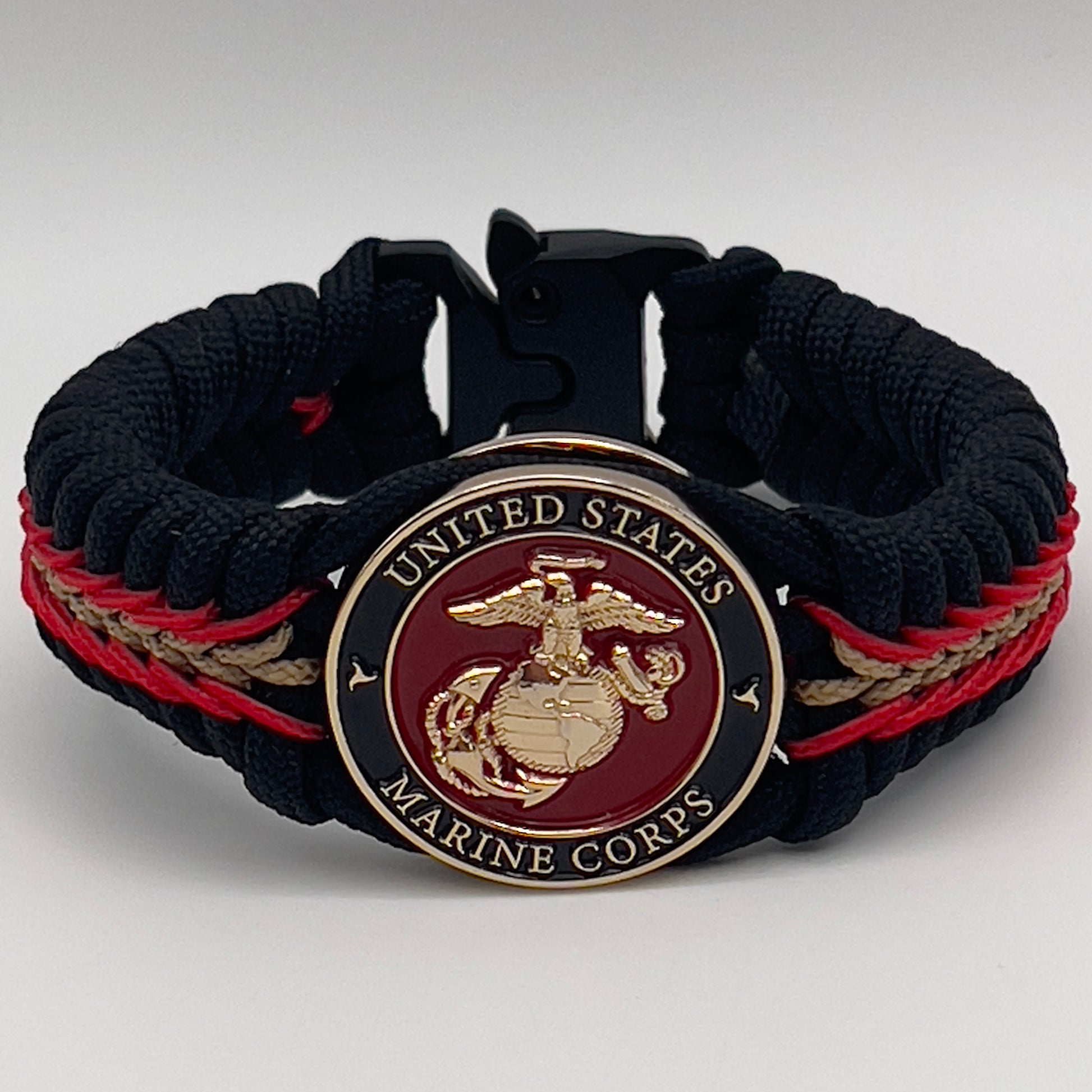 Thick, semi-rigid and comfortable braided United States Marine Corps bracelet featuring a 24K gold and silver plated USMC officer Eagle Globe and Anchor medallion, a black Cobra style tactical buckle and woven with black 550, Imperial red and gold micro paracord.
