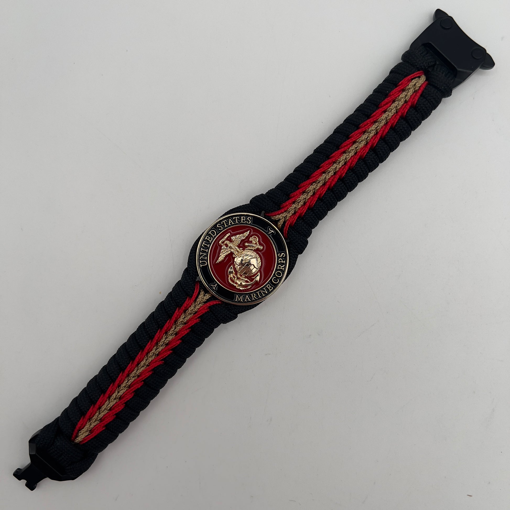Thick, semi-rigid and comfortable braided United States Marine Corps bracelet featuring a 24K gold and silver plated USMC officer Eagle Globe and Anchor medallion, a black Cobra style tactical buckle and woven with black 550, Imperial red and gold micro paracord.