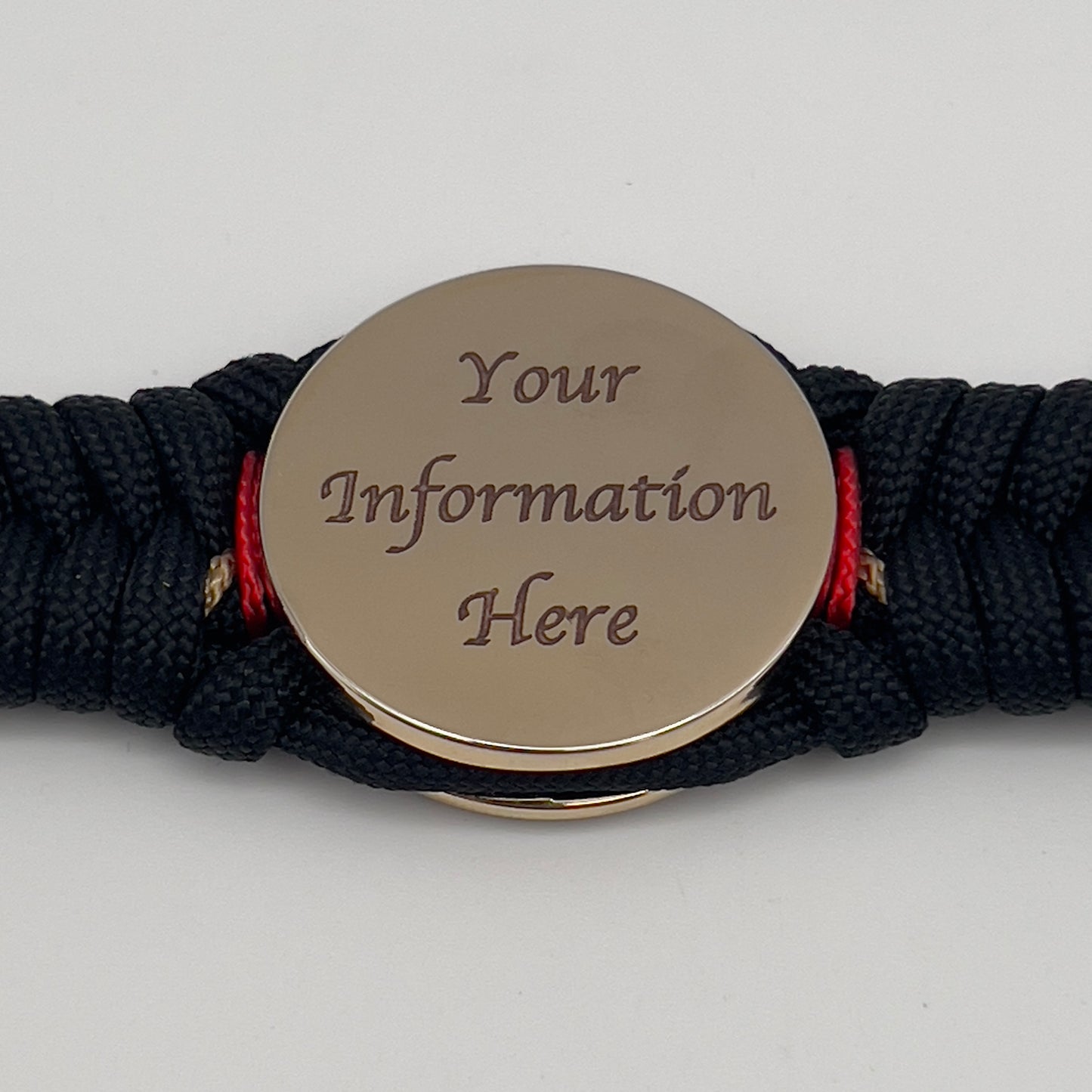 Thick, semi-rigid and comfortable braided United States Marine Corps bracelet featuring a 24K gold and silver plated USMC officer Eagle Globe and Anchor medallion, a black Cobra style tactical buckle and woven with black 550, Imperial red and gold micro paracord.