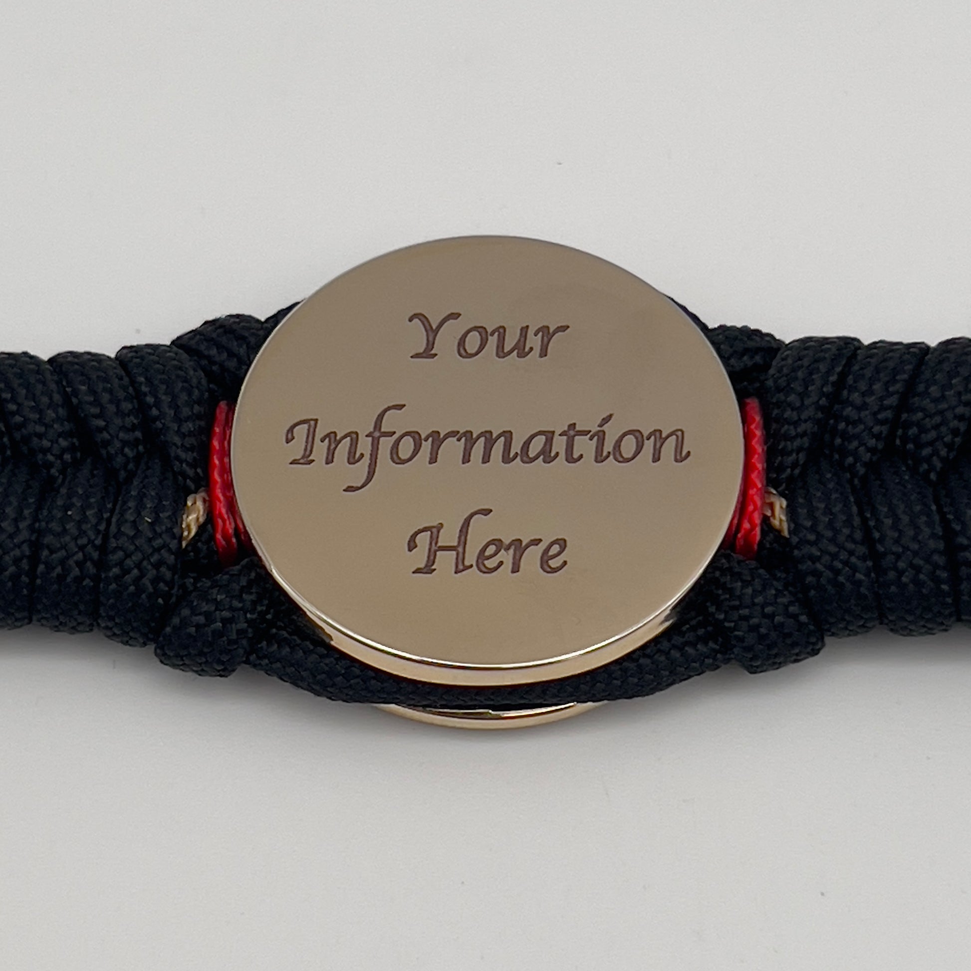 Thick, semi-rigid and comfortable braided United States Marine Corps bracelet featuring a 24K gold and silver plated USMC officer Eagle Globe and Anchor medallion, a black Cobra style tactical buckle and woven with black 550, Imperial red and gold micro paracord.
