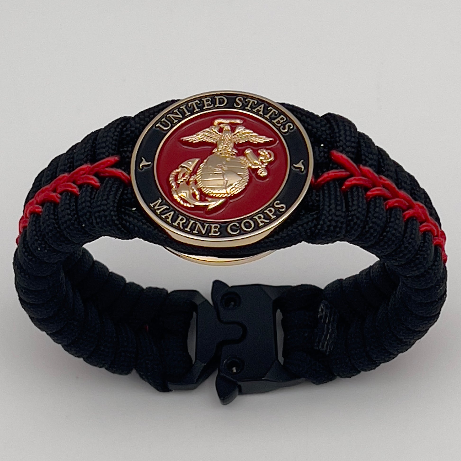 Thick, semi-rigid and comfortable braided United States Marine Corps bracelet featuring a 24K gold plated USMC officer Eagle Globe and Anchor medallion, a black Cobra style tactical buckle and woven with black 550 paracord and Imperial Red micro cord.