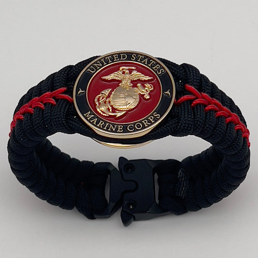 Thick, semi-rigid and comfortable braided United States Marine Corps bracelet featuring a 24K gold plated USMC officer Eagle Globe and Anchor medallion, a black Cobra style tactical buckle and woven with black 550 paracord and Imperial Red micro cord.