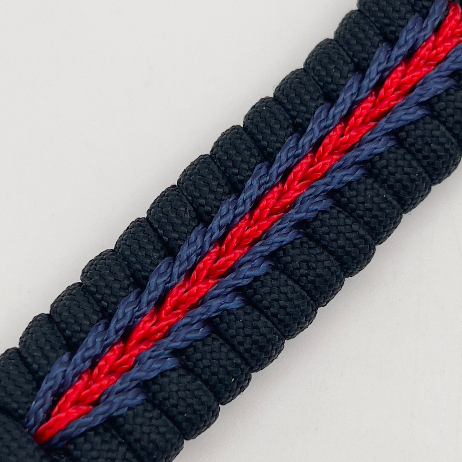 Thick, rigid and comfortable braided United States Marine Corps bracelet featuring a 24K gold plated USMC officer Eagle Globe and Anchor medallion, a black Cobra style tactical buckle and woven with black 550, Imperial red and Navy Blue micro paracord.
