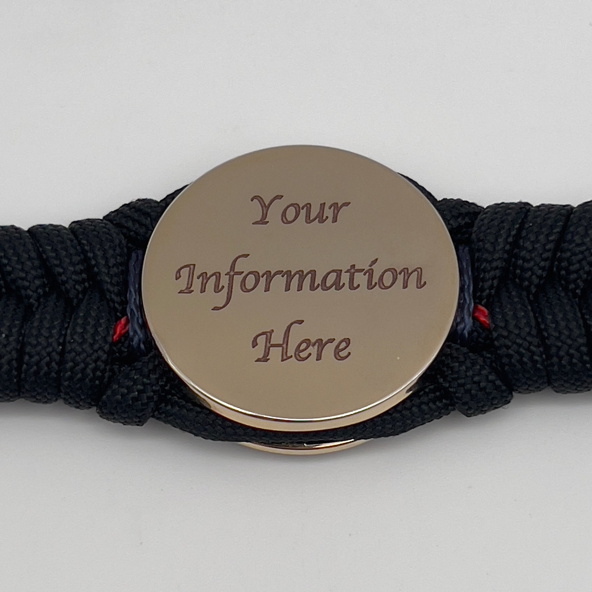 Thick, rigid and comfortable braided United States Marine Corps bracelet featuring a 24K gold plated USMC officer Eagle Globe and Anchor medallion, a black Cobra style tactical buckle and woven with black 550, Imperial red and Navy Blue micro paracord.