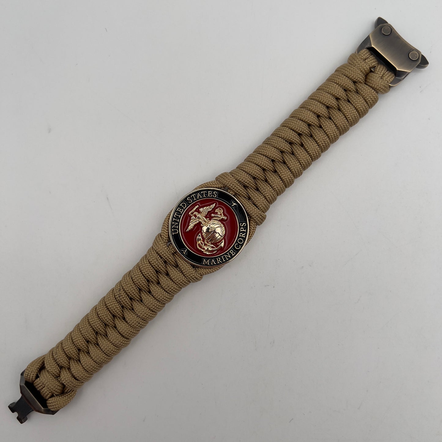 Thick, semi-rigid and comfortable braided United States Marine Corps bracelet featuring a 24K gold plated USMC officer Eagle Globe and Anchor medallion, a gold Cobra style tactical buckle and woven with gold 550 paracord.