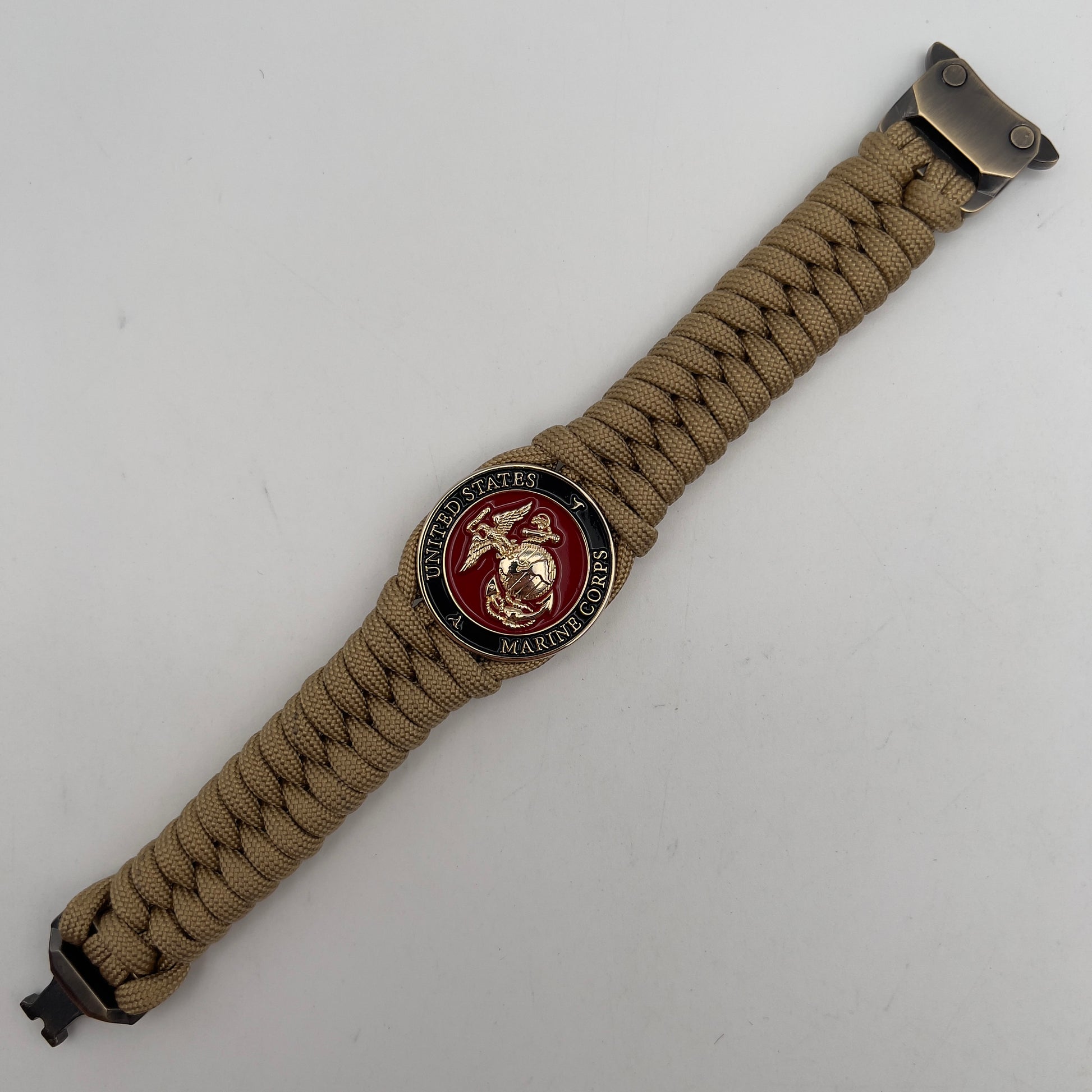 Thick, semi-rigid and comfortable braided United States Marine Corps bracelet featuring a 24K gold plated USMC officer Eagle Globe and Anchor medallion, a gold Cobra style tactical buckle and woven with gold 550 paracord.