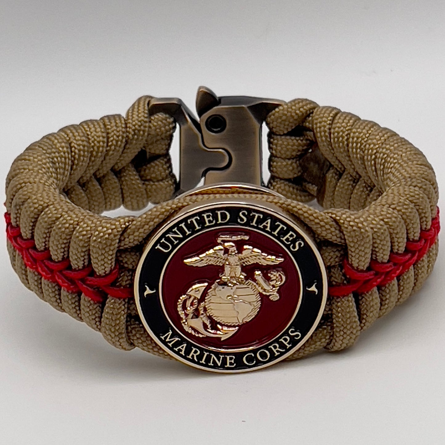 Thick, semi-rigid and comfortable braided United States Marine Corps bracelet featuring a 24K gold plated USMC officer Eagle Globe and Anchor medallion, a gold Cobra style tactical buckle and woven with gold 550 paracord and Imperial Red micro cord.