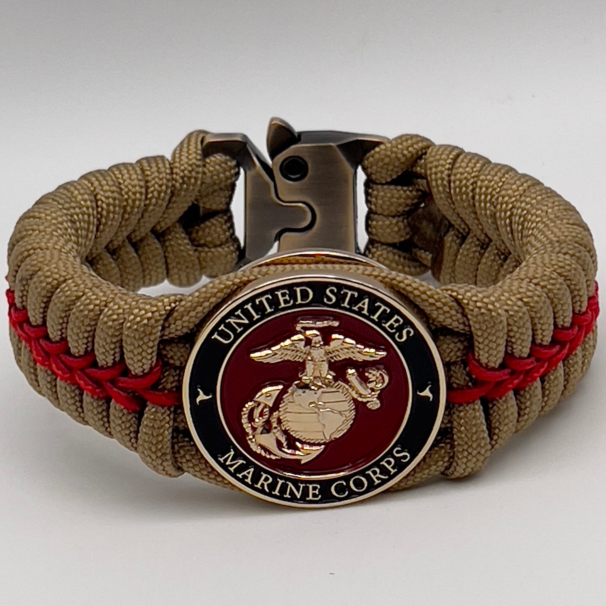 Thick, semi-rigid and comfortable braided United States Marine Corps bracelet featuring a 24K gold plated USMC officer Eagle Globe and Anchor medallion, a gold Cobra style tactical buckle and woven with gold 550 paracord and Imperial Red micro cord.