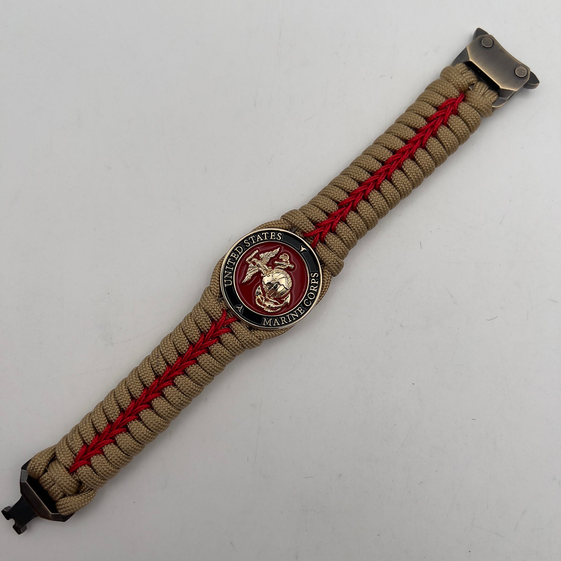 Thick, semi-rigid and comfortable braided United States Marine Corps bracelet featuring a 24K gold plated USMC officer Eagle Globe and Anchor medallion, a gold Cobra style tactical buckle and woven with gold 550 paracord and Imperial Red micro cord.
