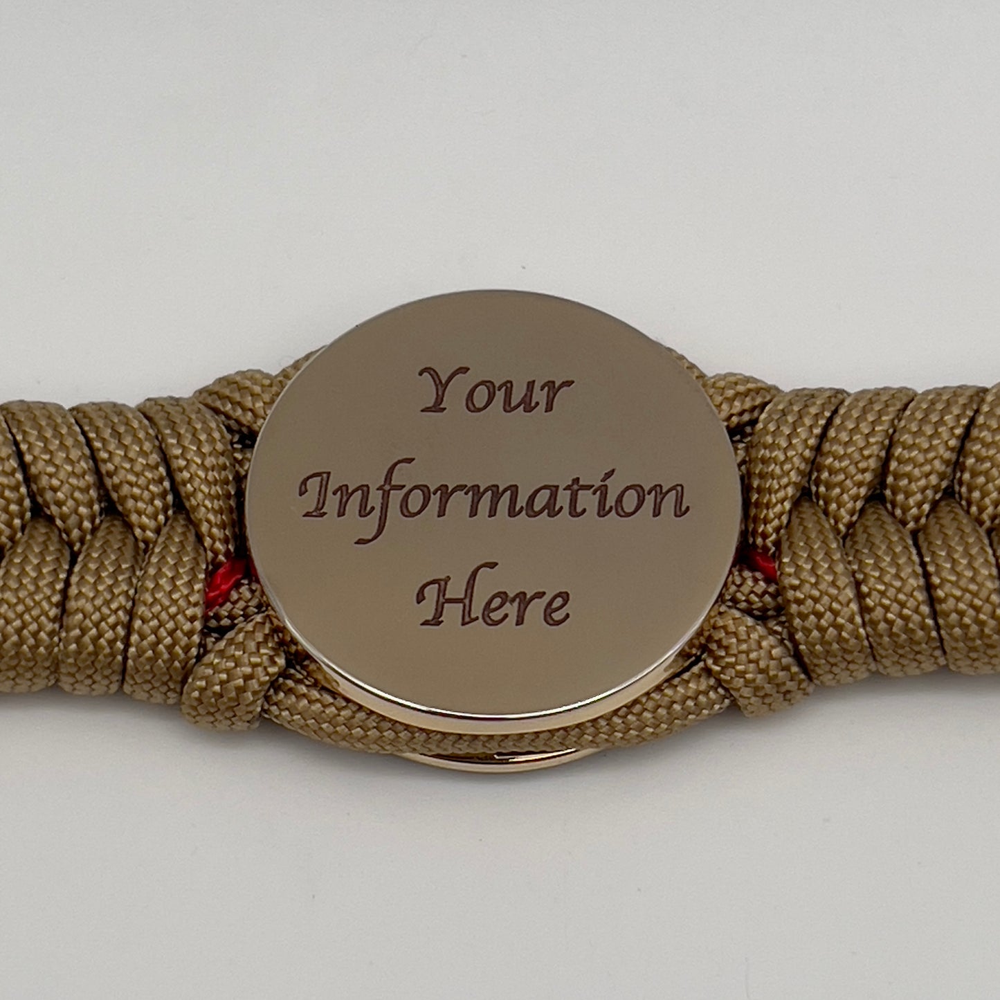 Thick, semi-rigid and comfortable braided United States Marine Corps bracelet featuring a 24K gold plated USMC officer Eagle Globe and Anchor medallion, a gold Cobra style tactical buckle and woven with gold 550 paracord and Imperial Red micro cord.