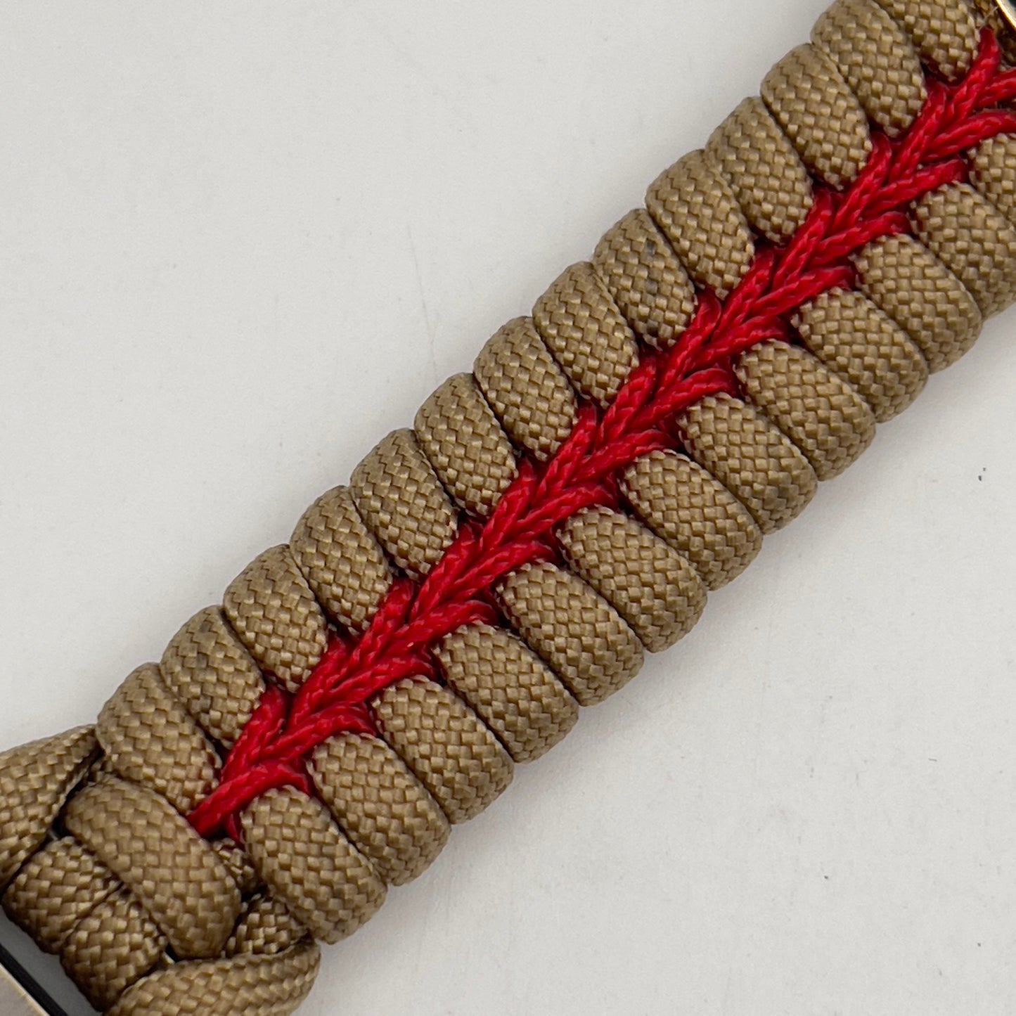 Thick, semi-rigid and comfortable braided United States Marine Corps bracelet featuring a 24K gold plated USMC officer Eagle Globe and Anchor medallion, a gold Cobra style tactical buckle and woven with gold 550 paracord and Imperial Red micro cord.
