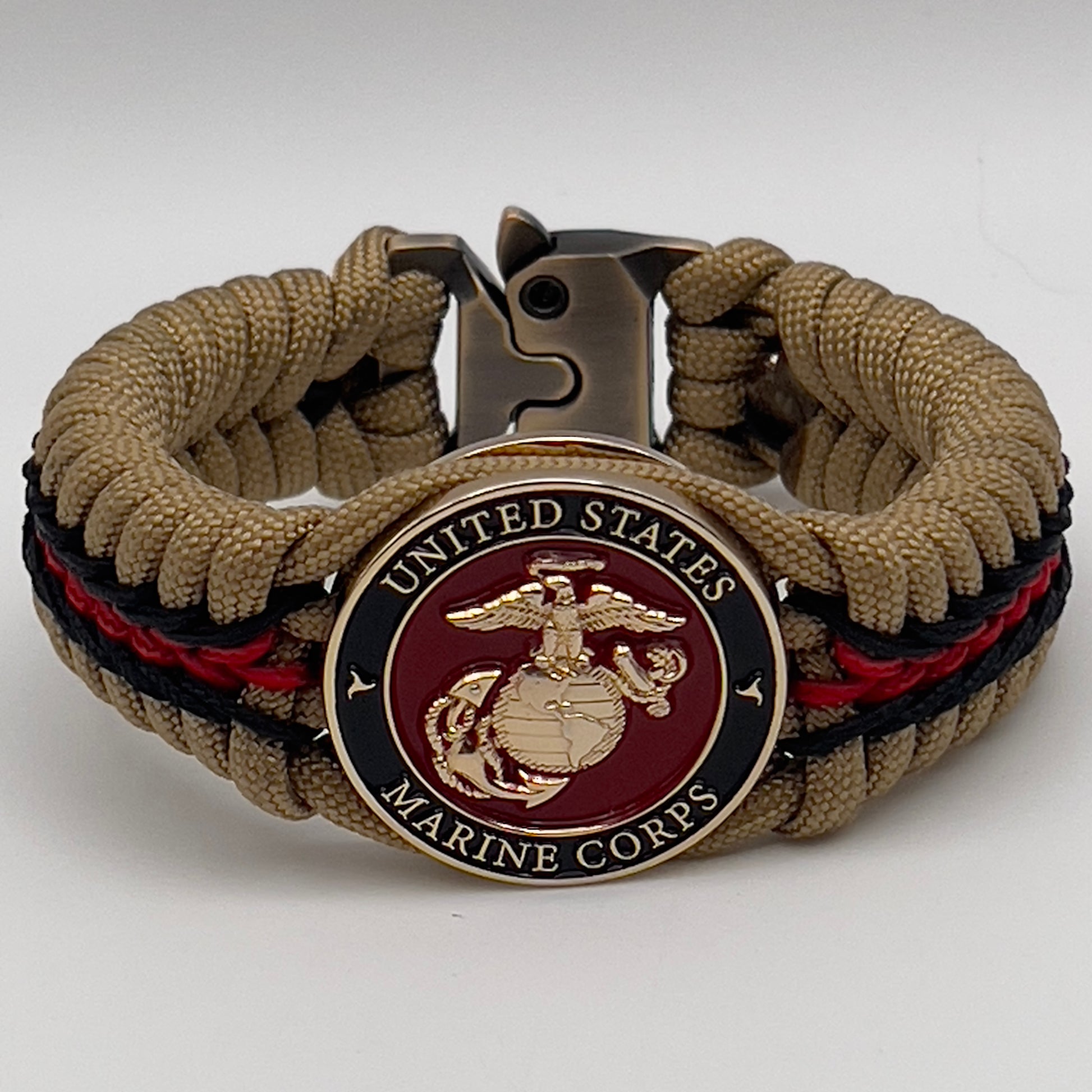 Thick, rigid and comfortable braided United States Marine Corps bracelet featuring a 24K gold plated USMC officer Eagle Globe and Anchor medallion, a gold Cobra style tactical buckle and woven with gold 550 paracord and Imperial Red and black micro cord.