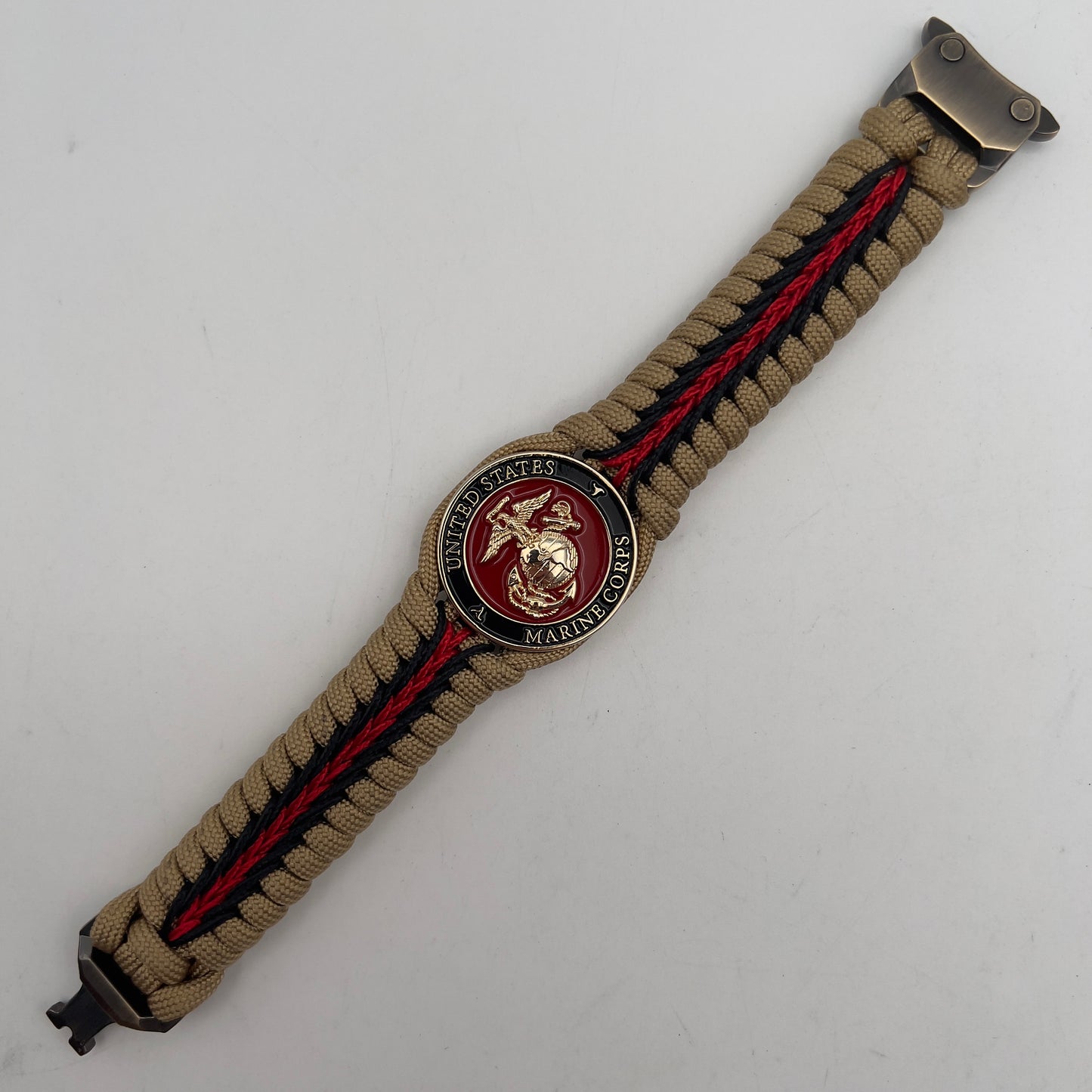Thick, rigid and comfortable braided United States Marine Corps bracelet featuring a 24K gold plated USMC officer Eagle Globe and Anchor medallion, a gold Cobra style tactical buckle and woven with gold 550 paracord and Imperial Red and black micro cord.