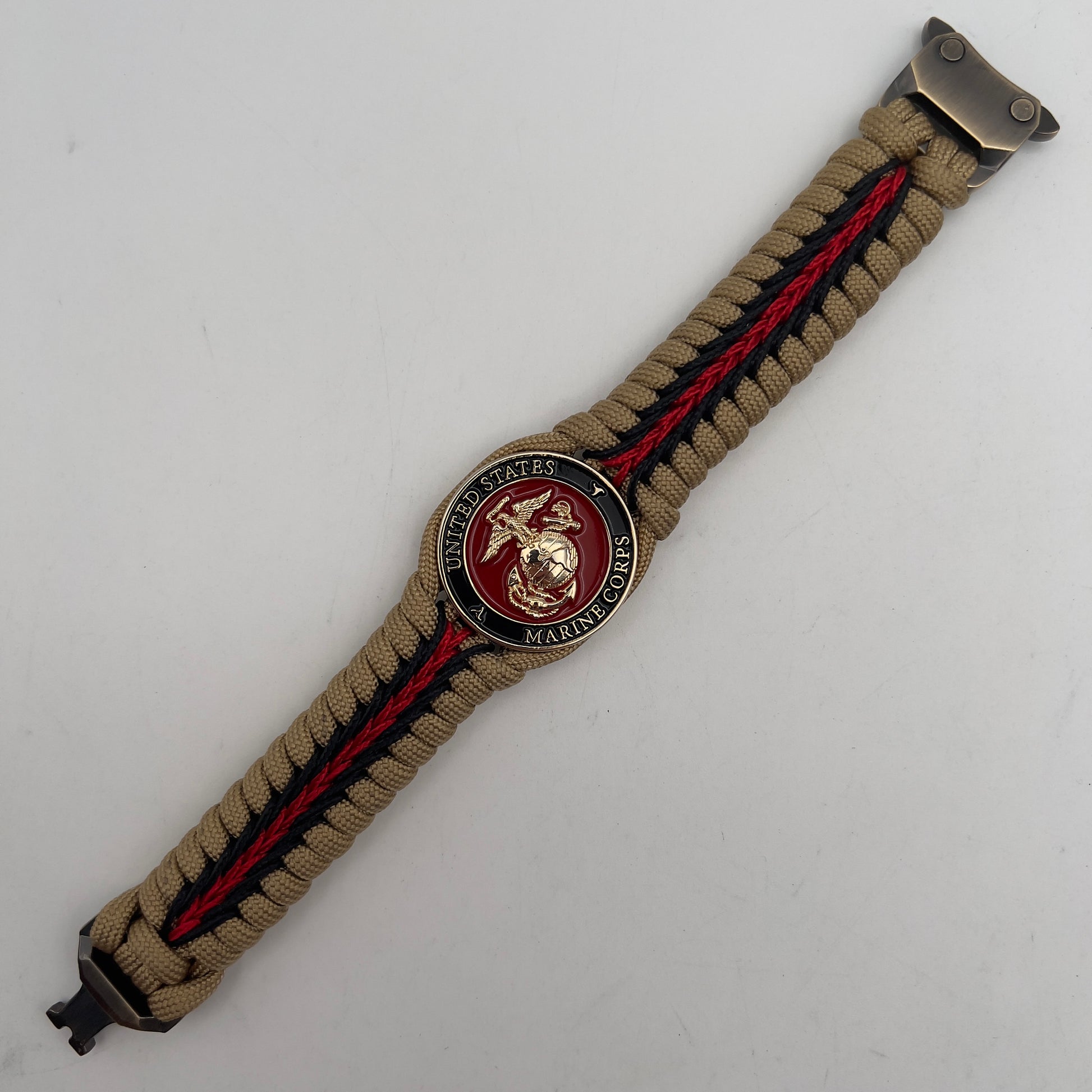 Thick, rigid and comfortable braided United States Marine Corps bracelet featuring a 24K gold plated USMC officer Eagle Globe and Anchor medallion, a gold Cobra style tactical buckle and woven with gold 550 paracord and Imperial Red and black micro cord.