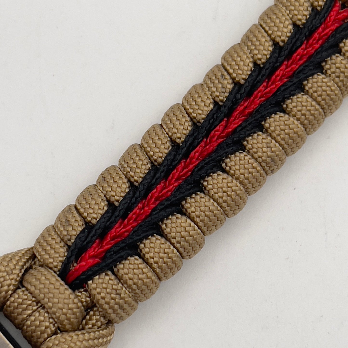 Thick, rigid and comfortable braided United States Marine Corps bracelet featuring a 24K gold plated USMC officer Eagle Globe and Anchor medallion, a gold Cobra style tactical buckle and woven with gold 550 paracord and Imperial Red and black micro cord.