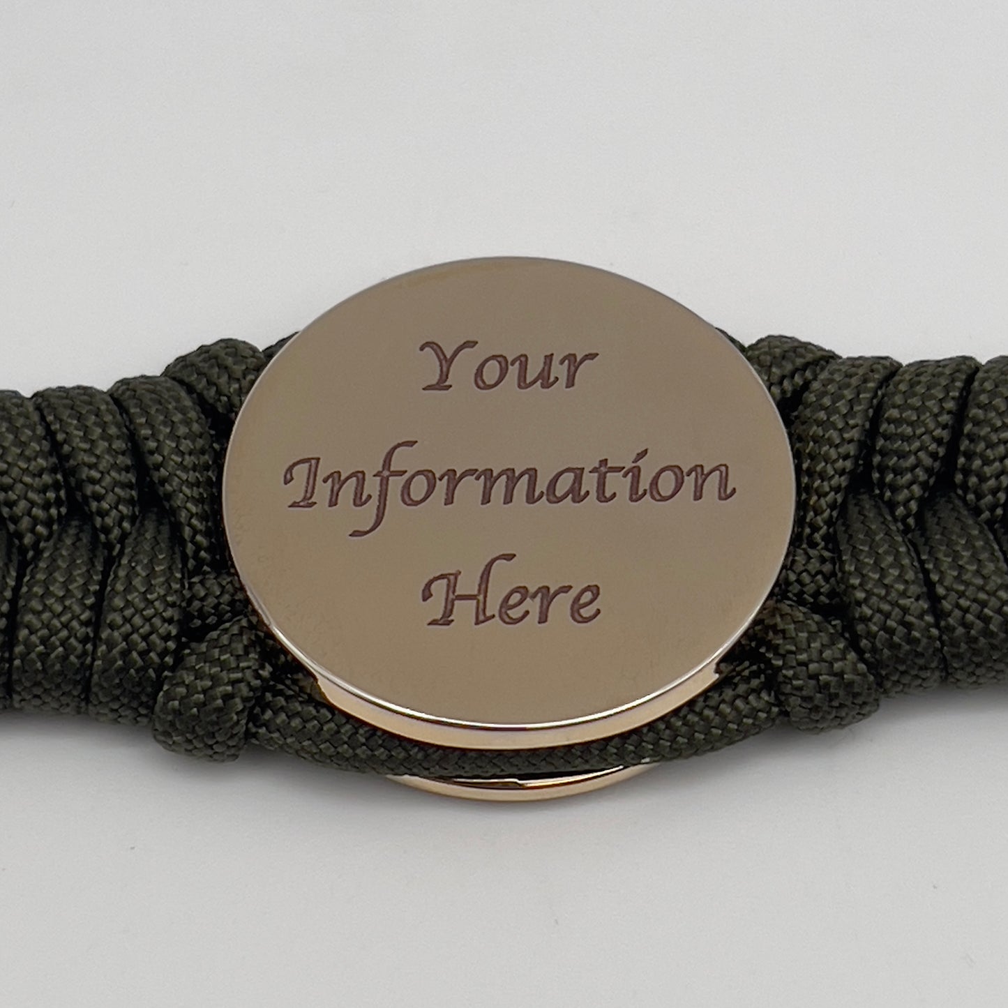 Thick, semi-rigid and comfortable braided United States Marine Corps bracelet featuring a 24K gold plated USMC officer Eagle Globe and Anchor medallion, a gold Cobra style tactical buckle and woven with olive drab 550 paracord.