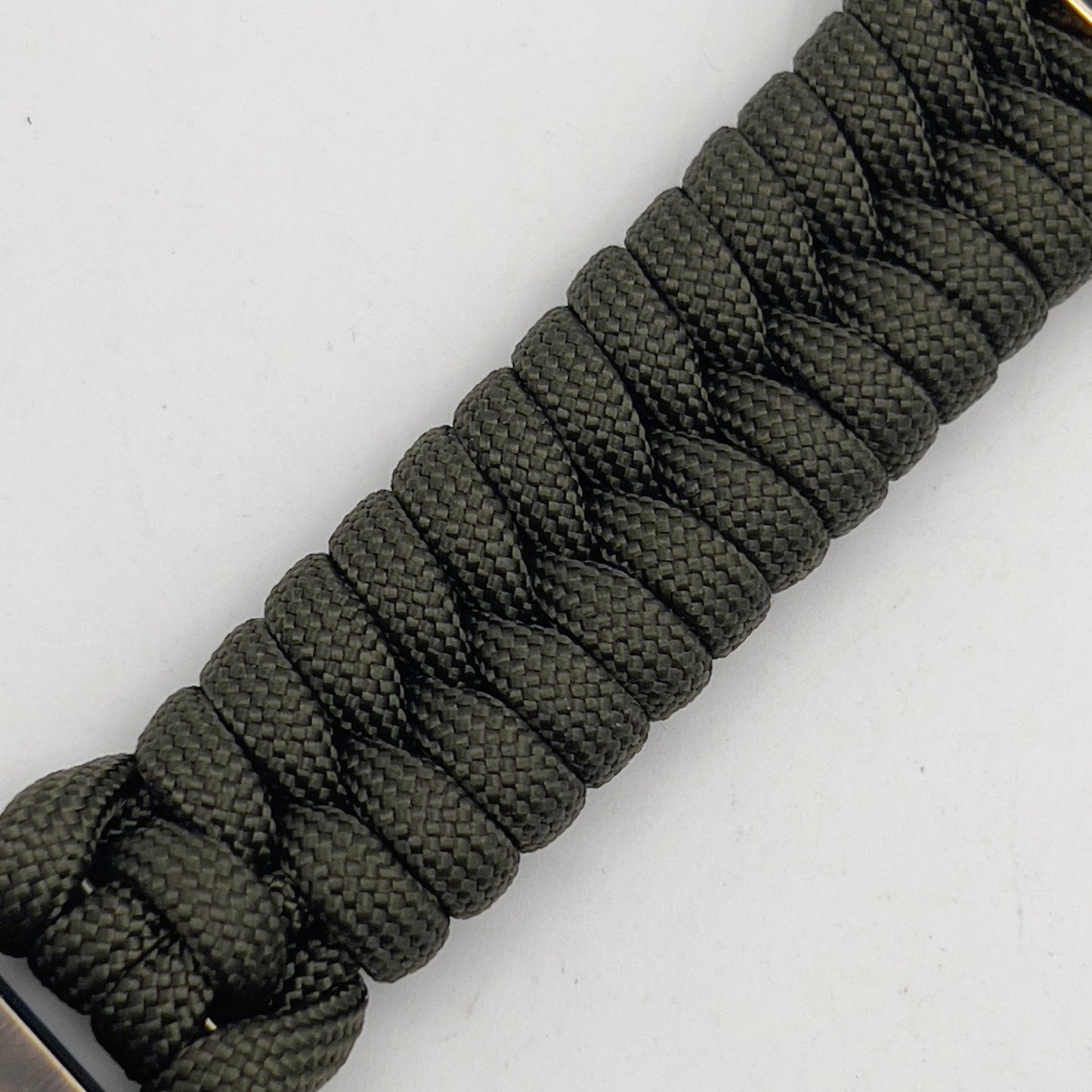 Thick, semi-rigid and comfortable braided United States Marine Corps bracelet featuring a 24K gold plated USMC officer Eagle Globe and Anchor medallion, a gold Cobra style tactical buckle and woven with olive drab 550 paracord.