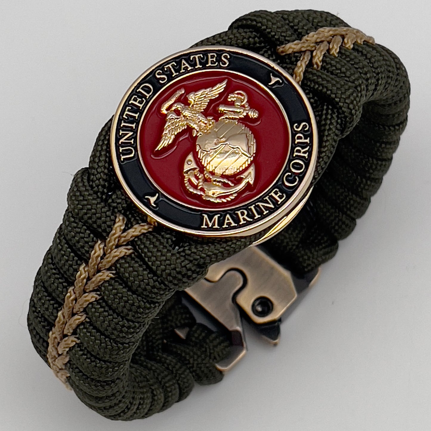 Thick, semi-rigid and comfortable braided United States Marine Corps bracelet featuring a 24K gold plated USMC officer Eagle Globe and Anchor medallion, a gold Cobra style tactical buckle and woven with olive drab 550 paracord and gold micro cord.