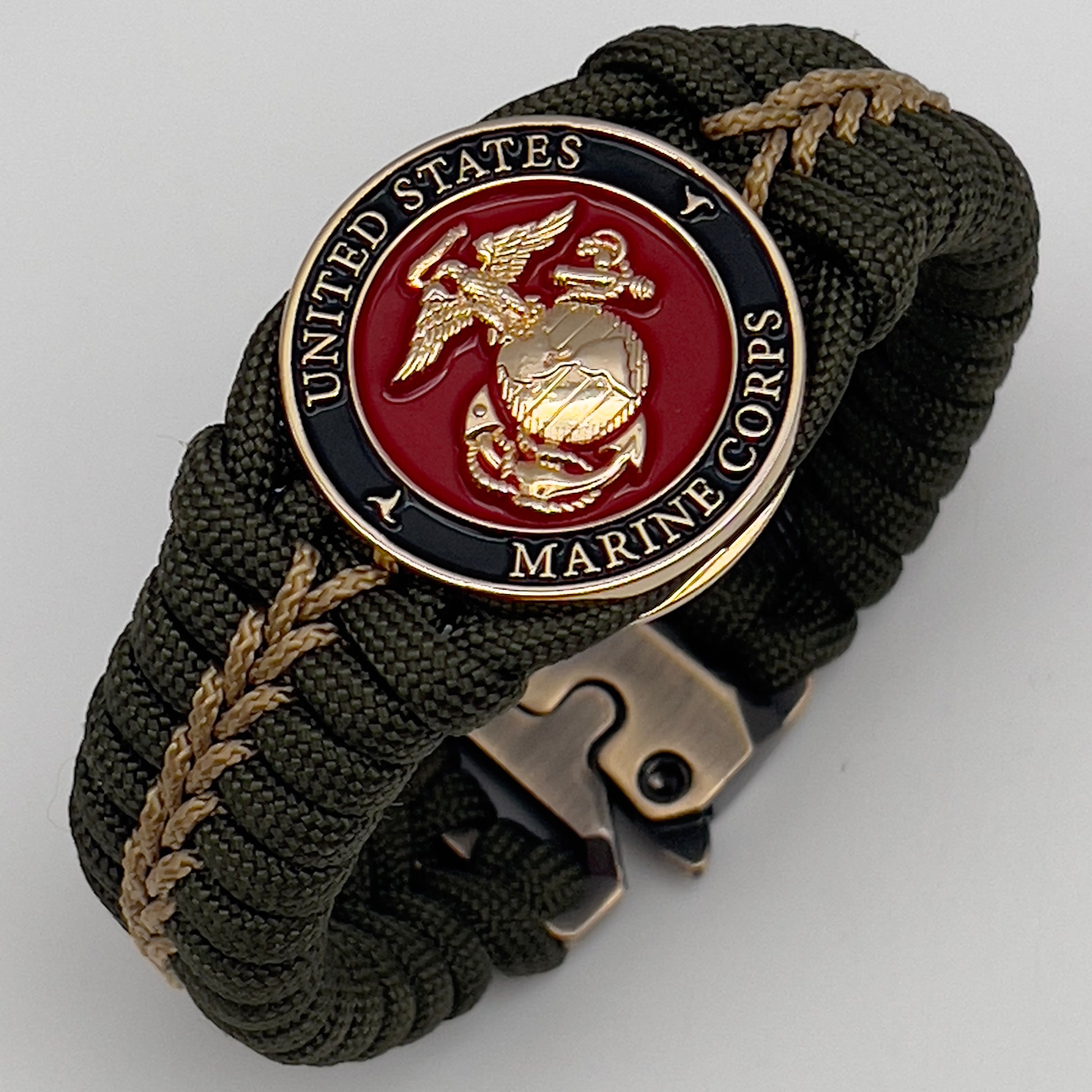 Thick, semi-rigid and comfortable braided United States Marine Corps bracelet featuring a 24K gold plated USMC officer Eagle Globe and Anchor medallion, a gold Cobra style tactical buckle and woven with olive drab 550 paracord and gold micro cord.