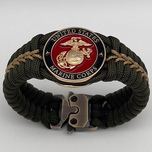 Thick, semi-rigid and comfortable braided United States Marine Corps bracelet featuring a 24K gold plated USMC officer Eagle Globe and Anchor medallion, a gold Cobra style tactical buckle and woven with olive drab 550 paracord and gold micro cord.