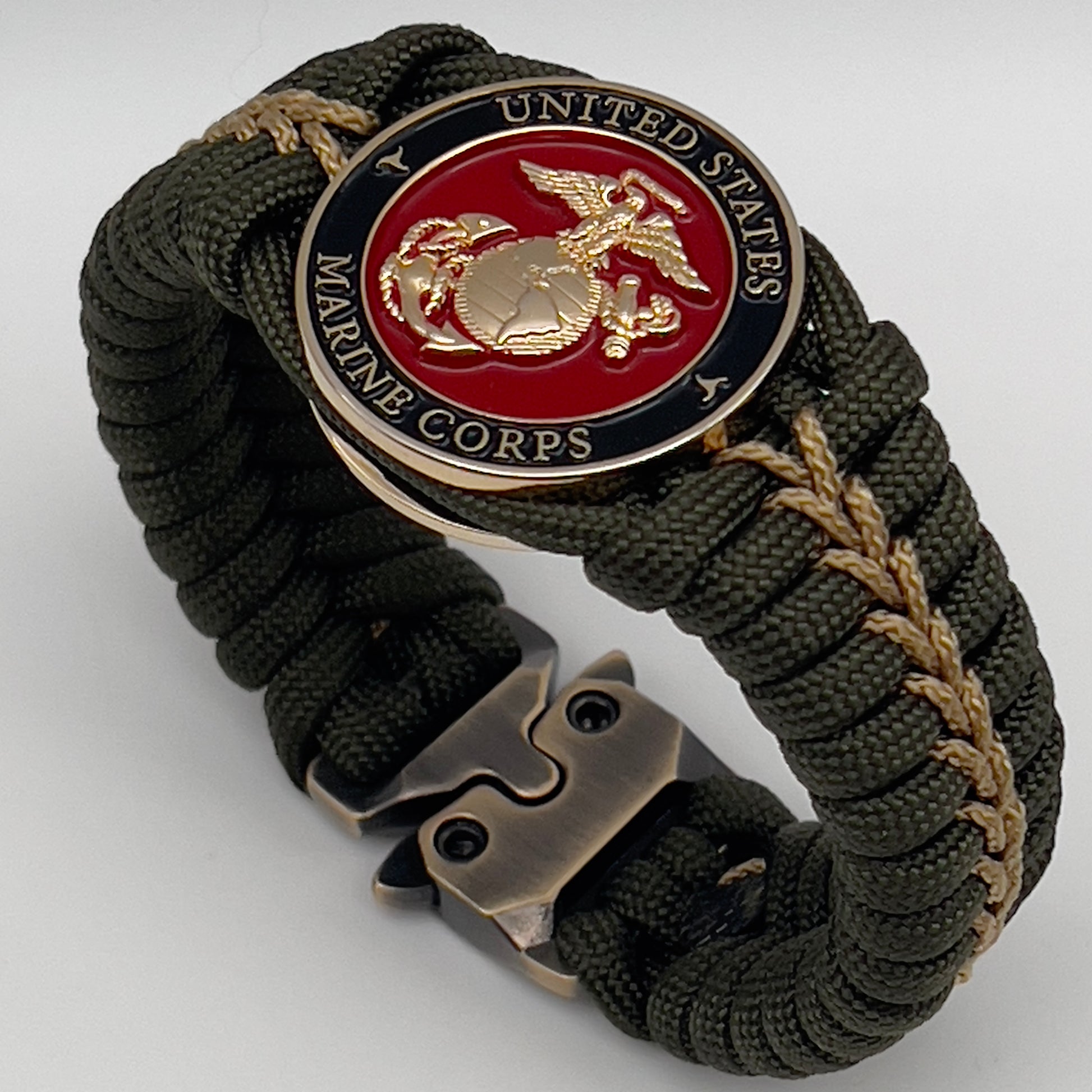 Thick, semi-rigid and comfortable braided United States Marine Corps bracelet featuring a 24K gold plated USMC officer Eagle Globe and Anchor medallion, a gold Cobra style tactical buckle and woven with olive drab 550 paracord and gold micro cord.
