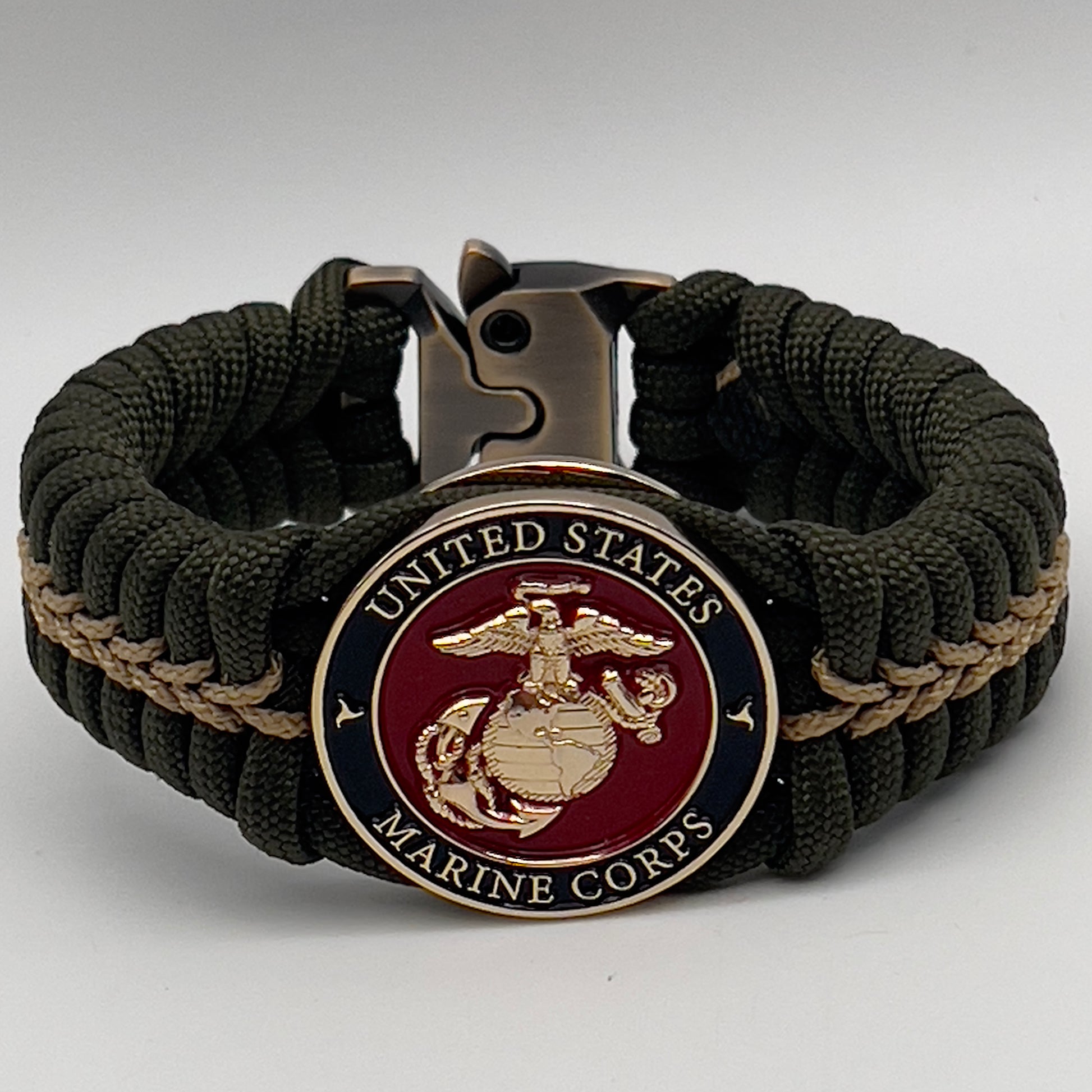 Thick, semi-rigid and comfortable braided United States Marine Corps bracelet featuring a 24K gold plated USMC officer Eagle Globe and Anchor medallion, a gold Cobra style tactical buckle and woven with olive drab 550 paracord and gold micro cord.