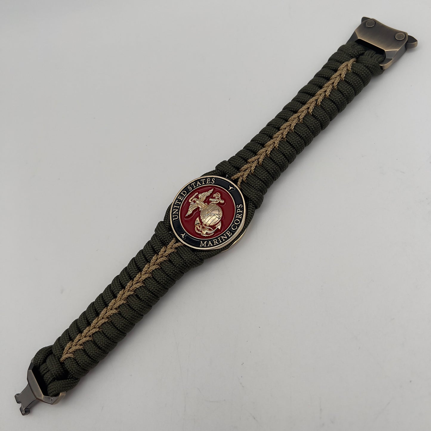 Thick, semi-rigid and comfortable braided United States Marine Corps bracelet featuring a 24K gold plated USMC officer Eagle Globe and Anchor medallion, a gold Cobra style tactical buckle and woven with olive drab 550 paracord and gold micro cord.