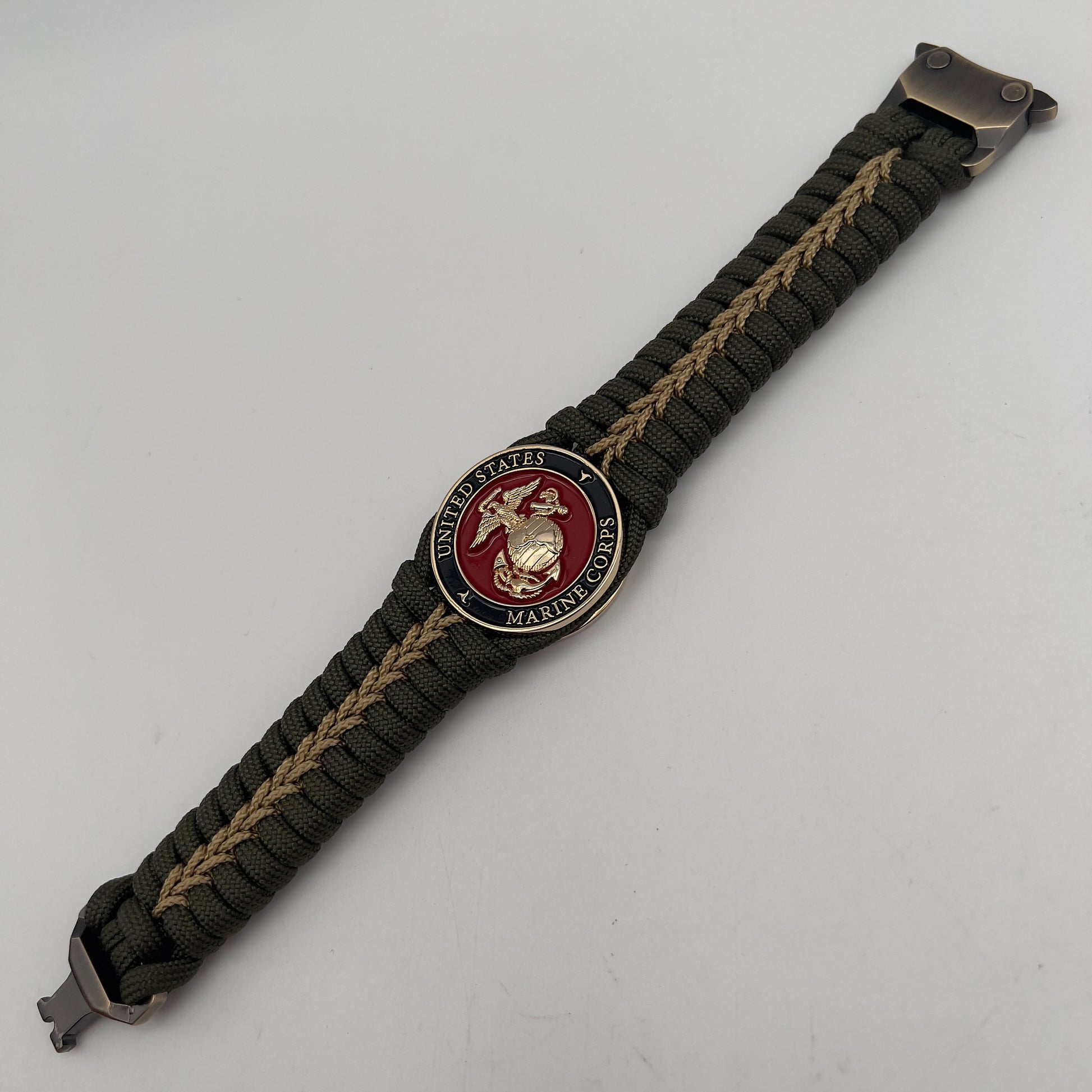 Thick, semi-rigid and comfortable braided United States Marine Corps bracelet featuring a 24K gold plated USMC officer Eagle Globe and Anchor medallion, a gold Cobra style tactical buckle and woven with olive drab 550 paracord and gold micro cord.