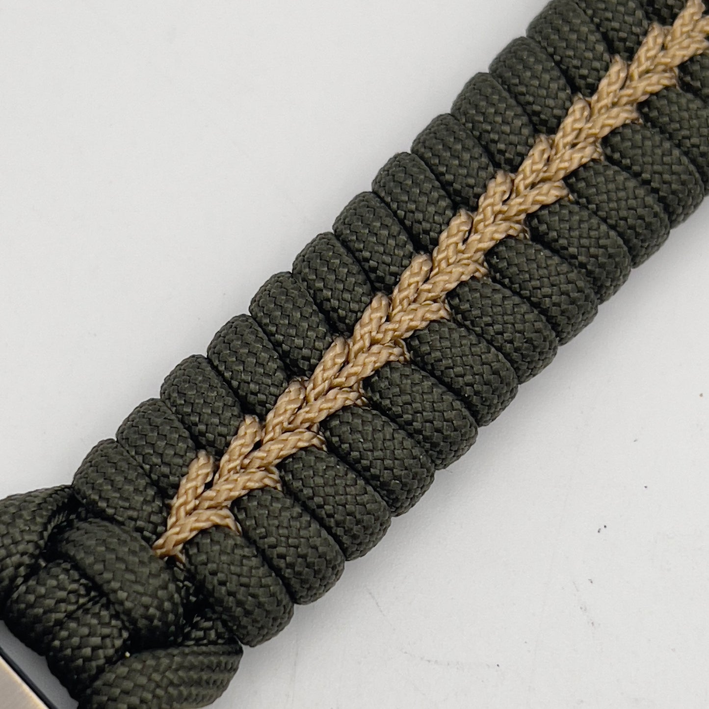 Thick, semi-rigid and comfortable braided United States Marine Corps bracelet featuring a 24K gold plated USMC officer Eagle Globe and Anchor medallion, a gold Cobra style tactical buckle and woven with olive drab 550 paracord and gold micro cord.