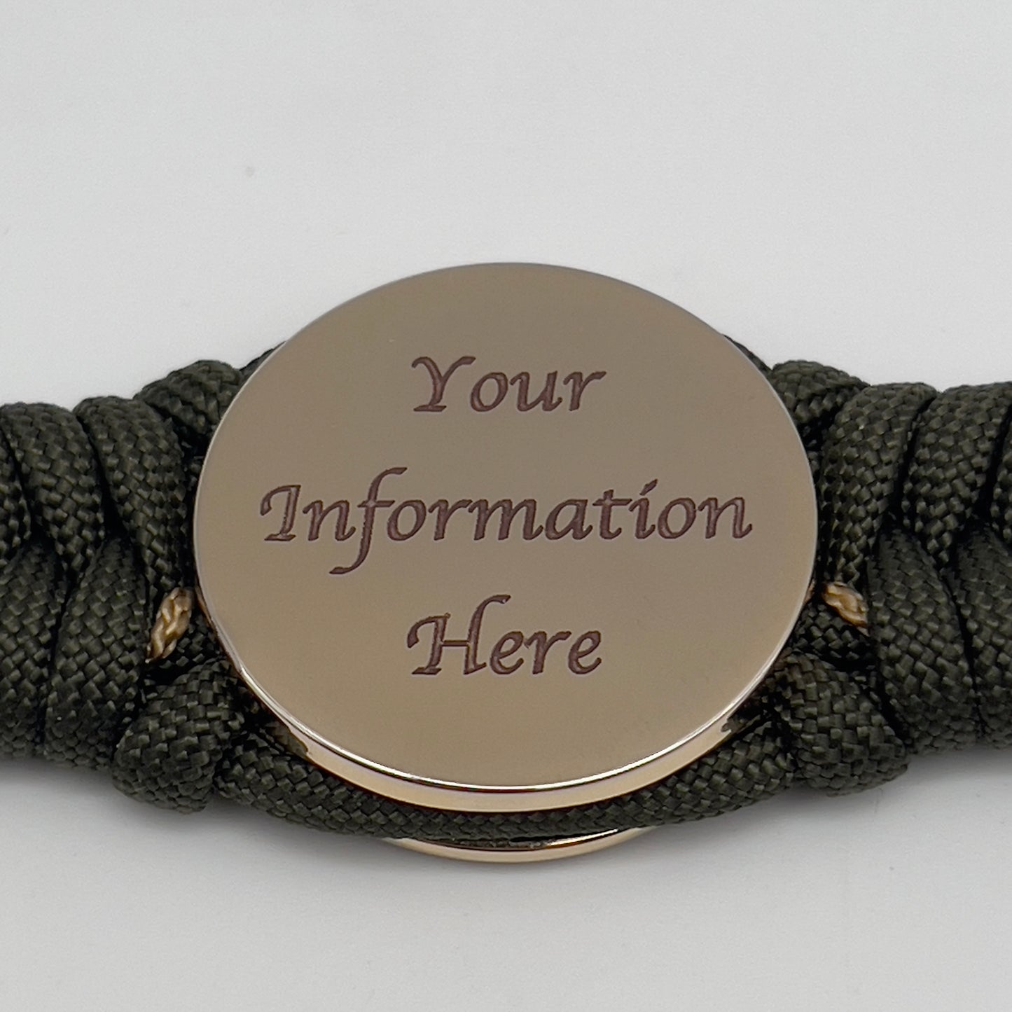 Thick, semi-rigid and comfortable braided United States Marine Corps bracelet featuring a 24K gold plated USMC officer Eagle Globe and Anchor medallion, a gold Cobra style tactical buckle and woven with olive drab 550 paracord and gold micro cord.