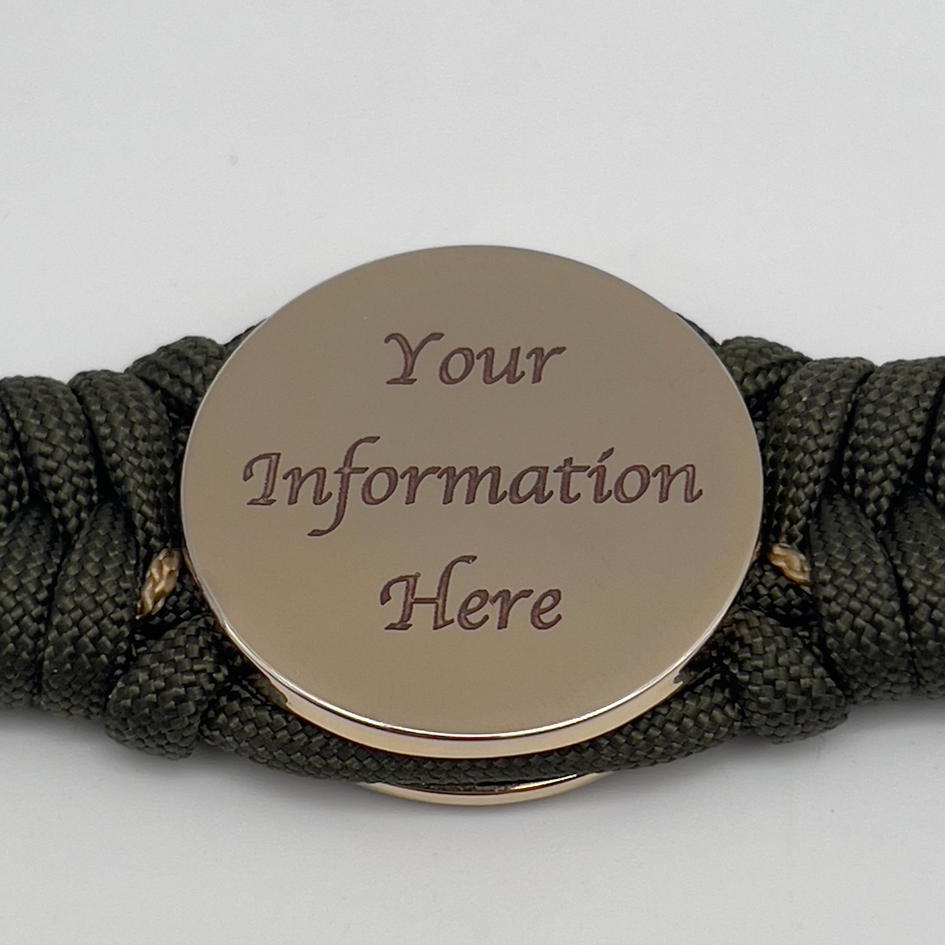 Thick, semi-rigid and comfortable braided United States Marine Corps bracelet featuring a 24K gold plated USMC officer Eagle Globe and Anchor medallion, a gold Cobra style tactical buckle and woven with olive drab 550 paracord and gold micro cord.