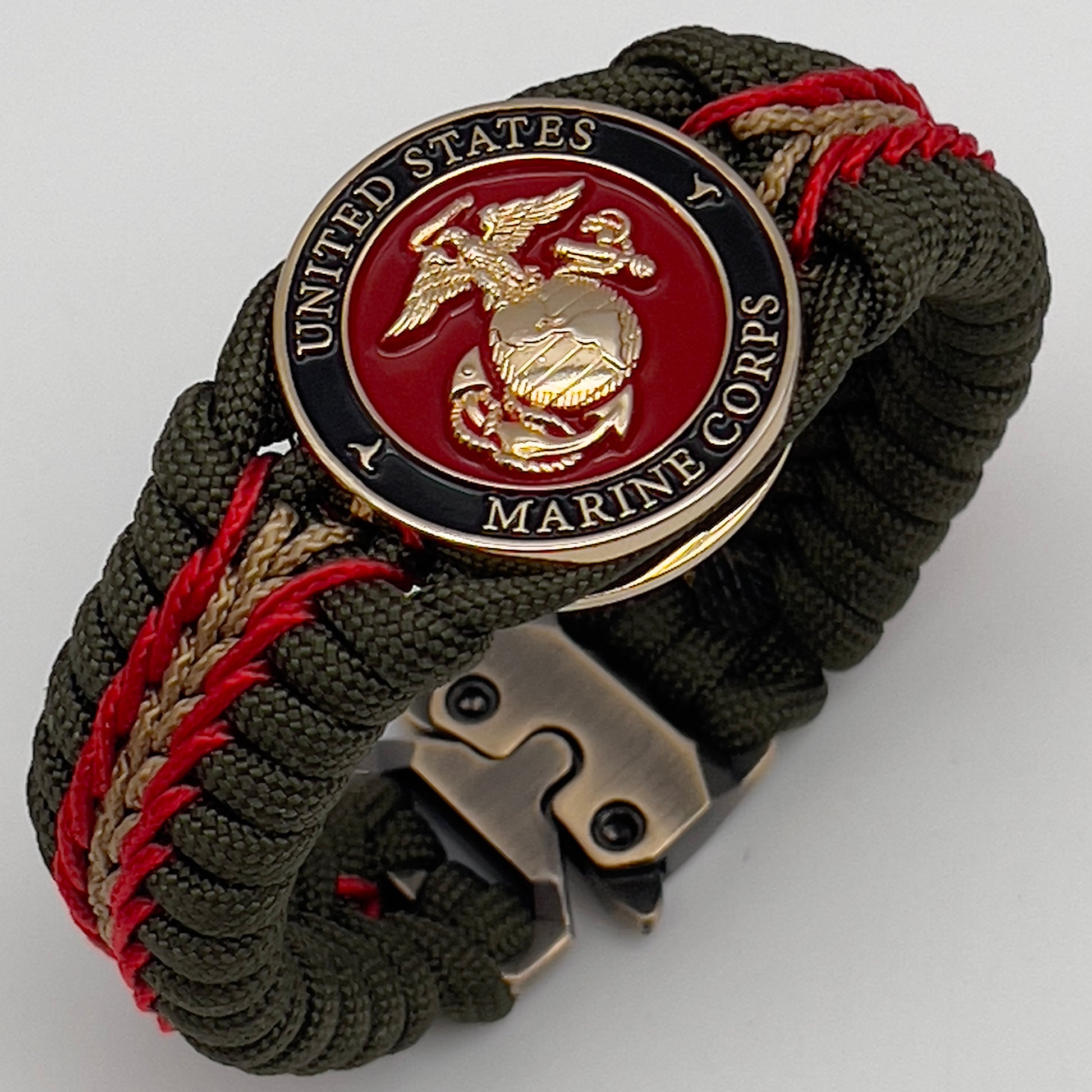 Thick, rigid and comfortable braided United States Marine Corps bracelet featuring a 24K gold plated USMC officer Eagle Globe and Anchor medallion, a gold Cobra style tactical buckle and woven with olive drab 550 paracord and Imperial Red and gold micro cord.