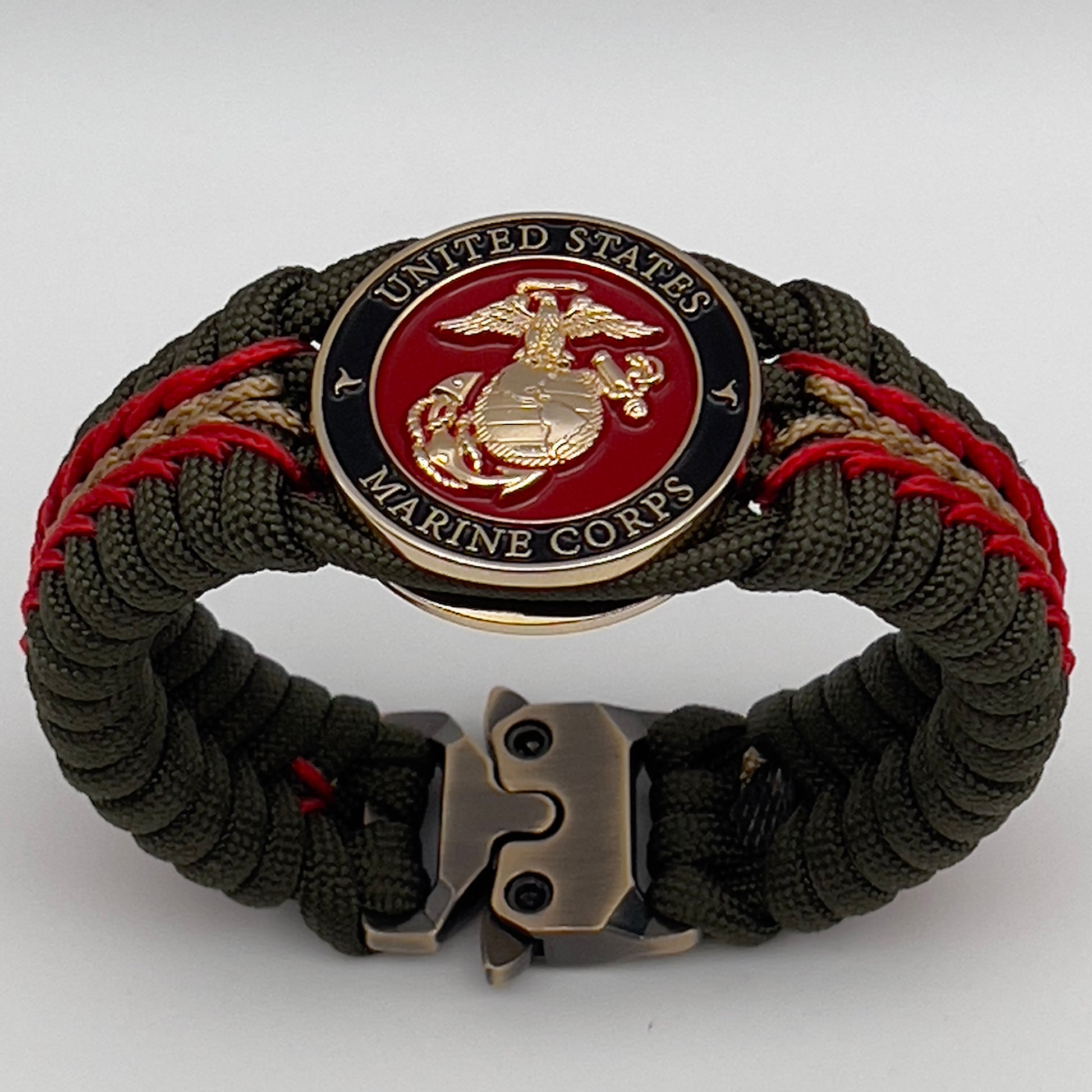 Thick, rigid and comfortable braided United States Marine Corps bracelet featuring a 24K gold plated USMC officer Eagle Globe and Anchor medallion, a gold Cobra style tactical buckle and woven with olive drab 550 paracord and Imperial Red and gold micro cord.