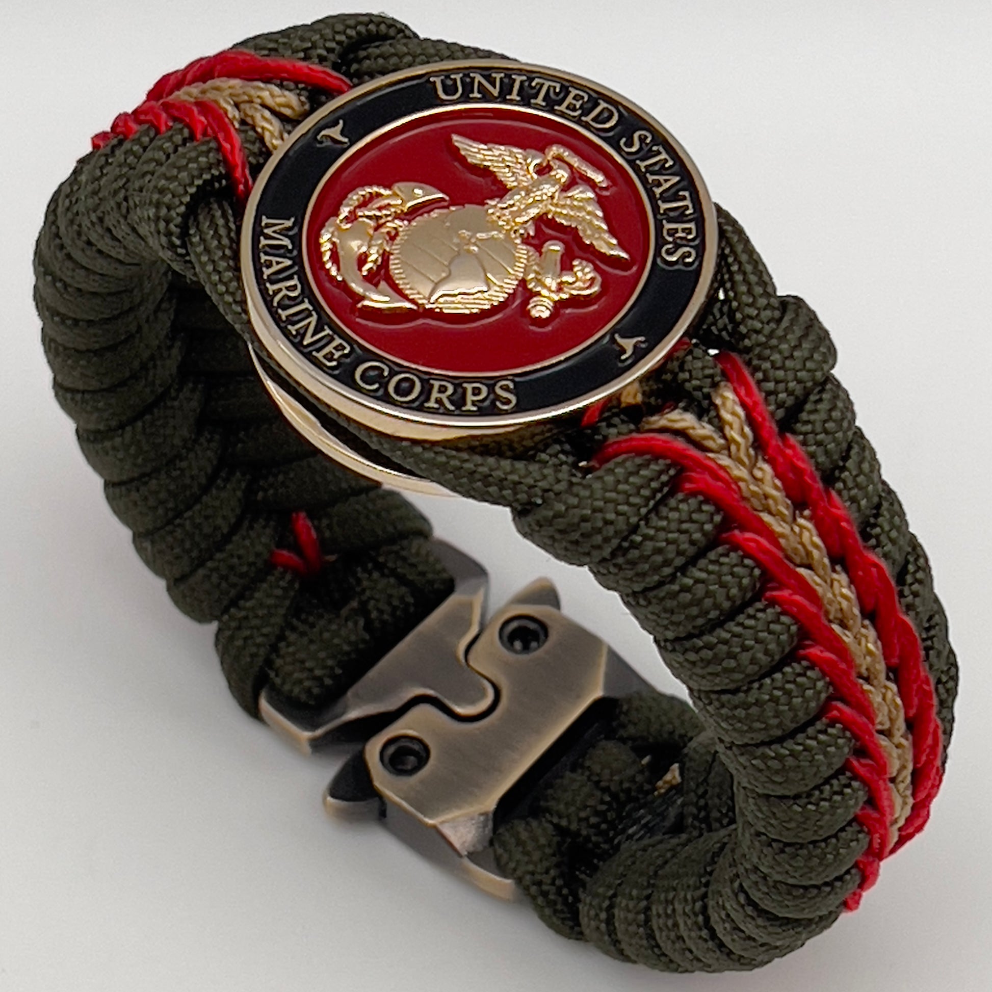 Thick, rigid and comfortable braided United States Marine Corps bracelet featuring a 24K gold plated USMC officer Eagle Globe and Anchor medallion, a gold Cobra style tactical buckle and woven with olive drab 550 paracord and Imperial Red and gold micro cord.