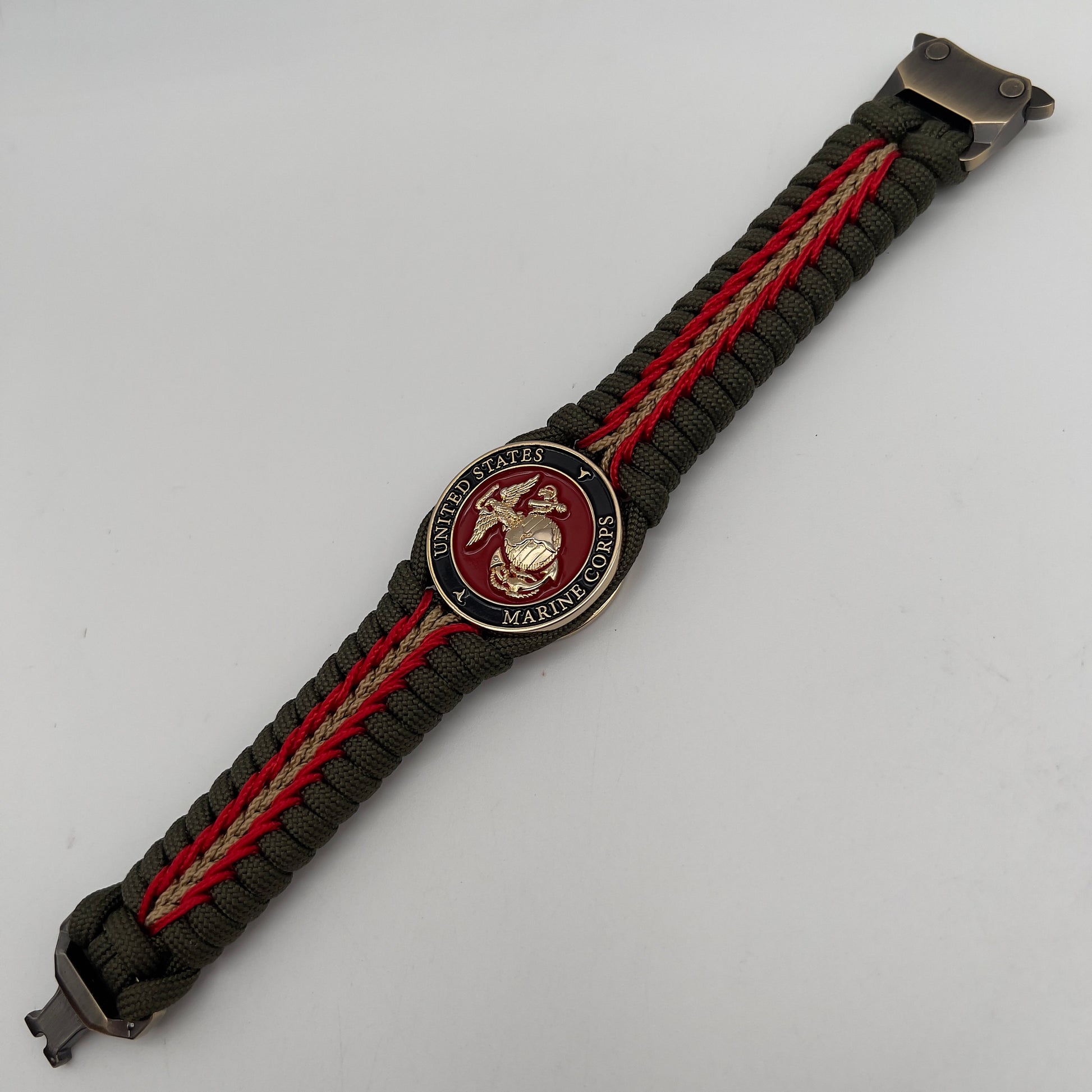 Thick, rigid and comfortable braided United States Marine Corps bracelet featuring a 24K gold plated USMC officer Eagle Globe and Anchor medallion, a gold Cobra style tactical buckle and woven with olive drab 550 paracord and Imperial Red and gold micro cord.