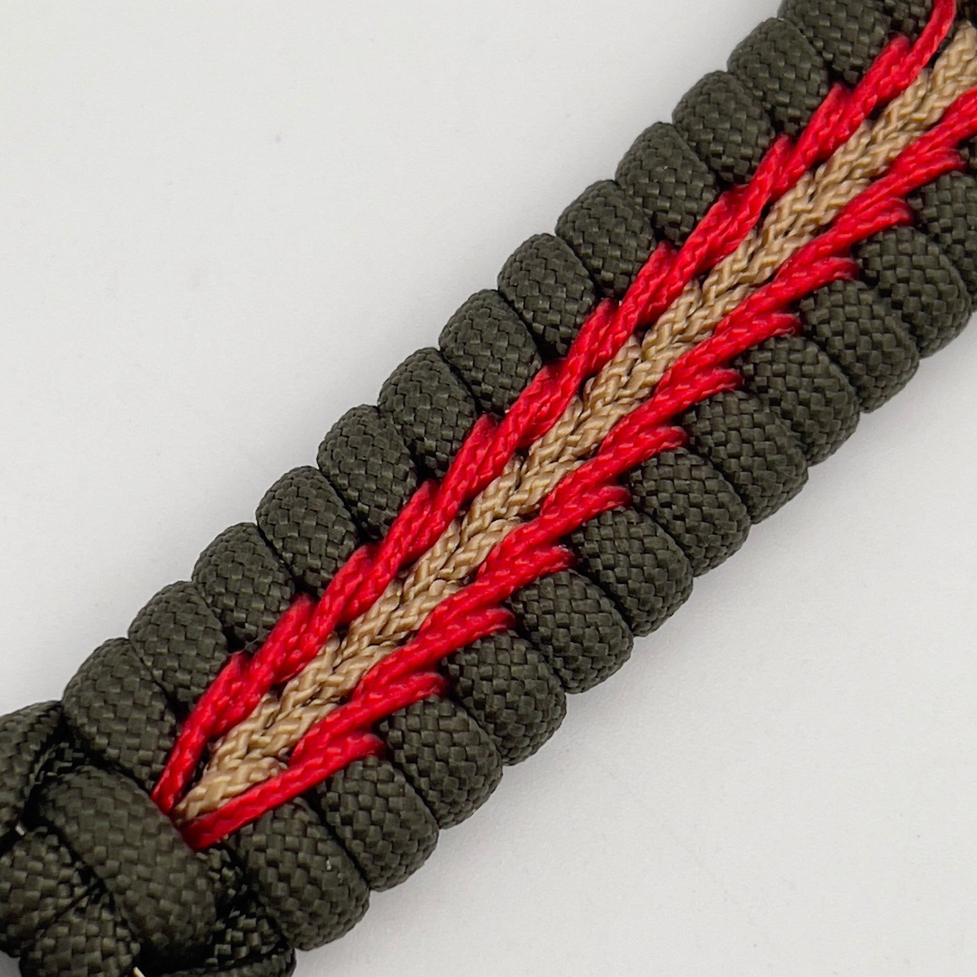 Thick, rigid and comfortable braided United States Marine Corps bracelet featuring a 24K gold plated USMC officer Eagle Globe and Anchor medallion, a gold Cobra style tactical buckle and woven with olive drab 550 paracord and Imperial Red and gold micro cord.