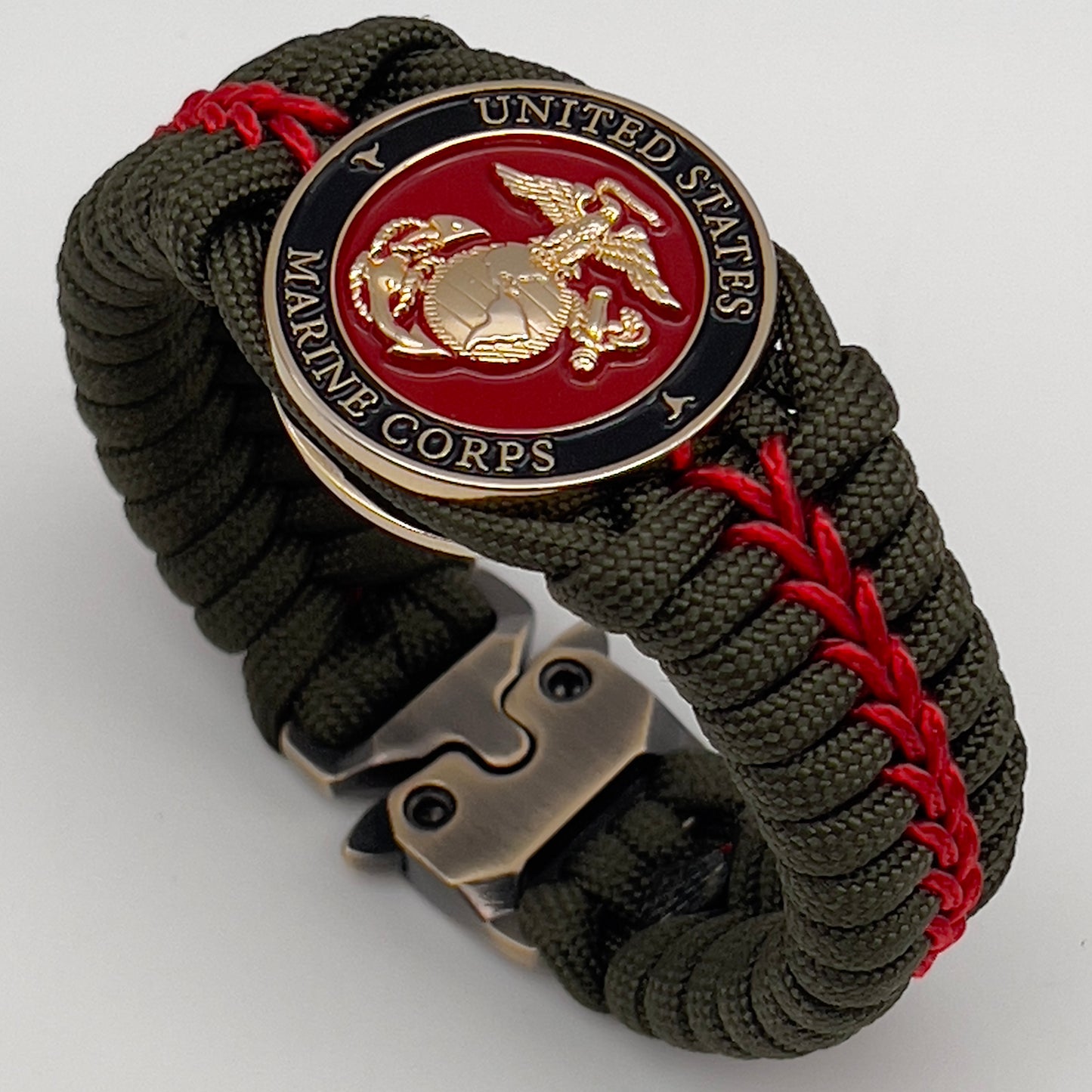 Thick, semi-rigid and comfortable braided United States Marine Corps bracelet featuring a 24K gold plated USMC officer Eagle Globe and Anchor medallion, a gold Cobra style tactical buckle and woven with olive drab 550 paracord and Imperial Red micro cord.