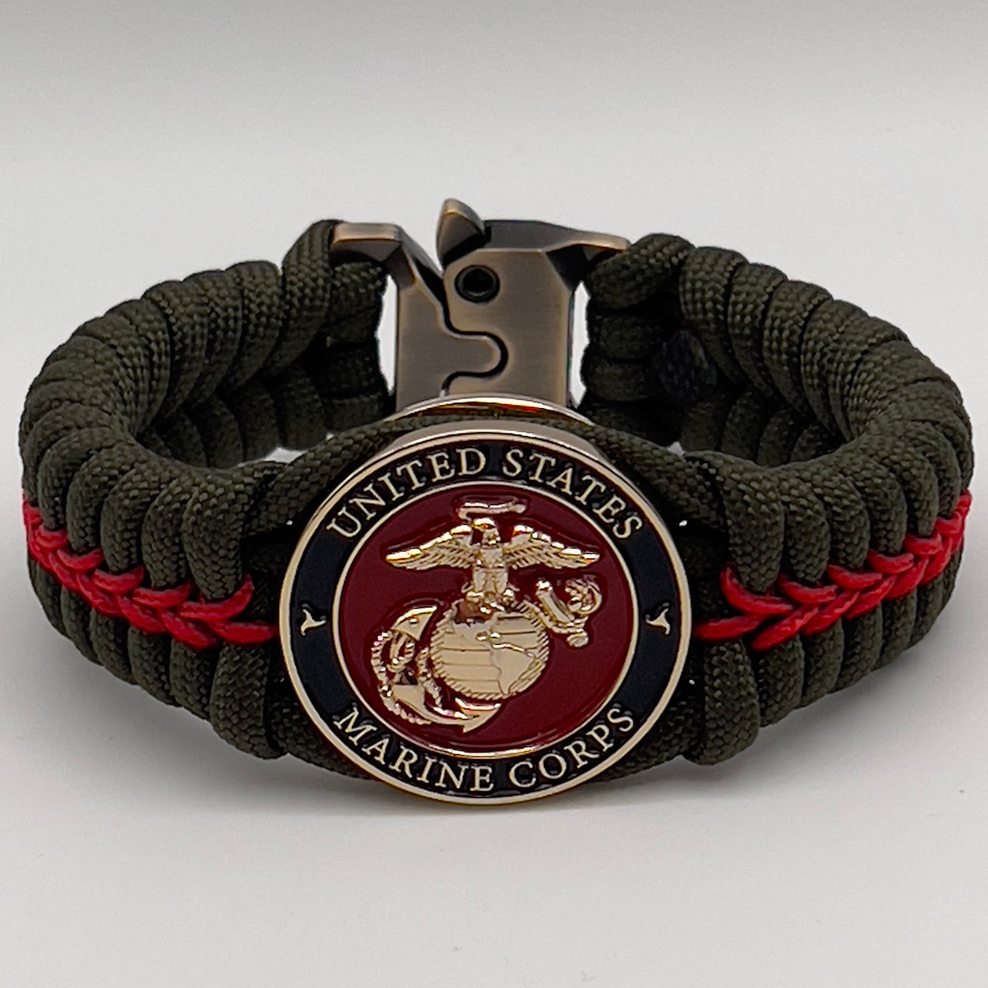 Thick, semi-rigid and comfortable braided United States Marine Corps bracelet featuring a 24K gold plated USMC officer Eagle Globe and Anchor medallion, a gold Cobra style tactical buckle and woven with olive drab 550 paracord and Imperial Red micro cord.