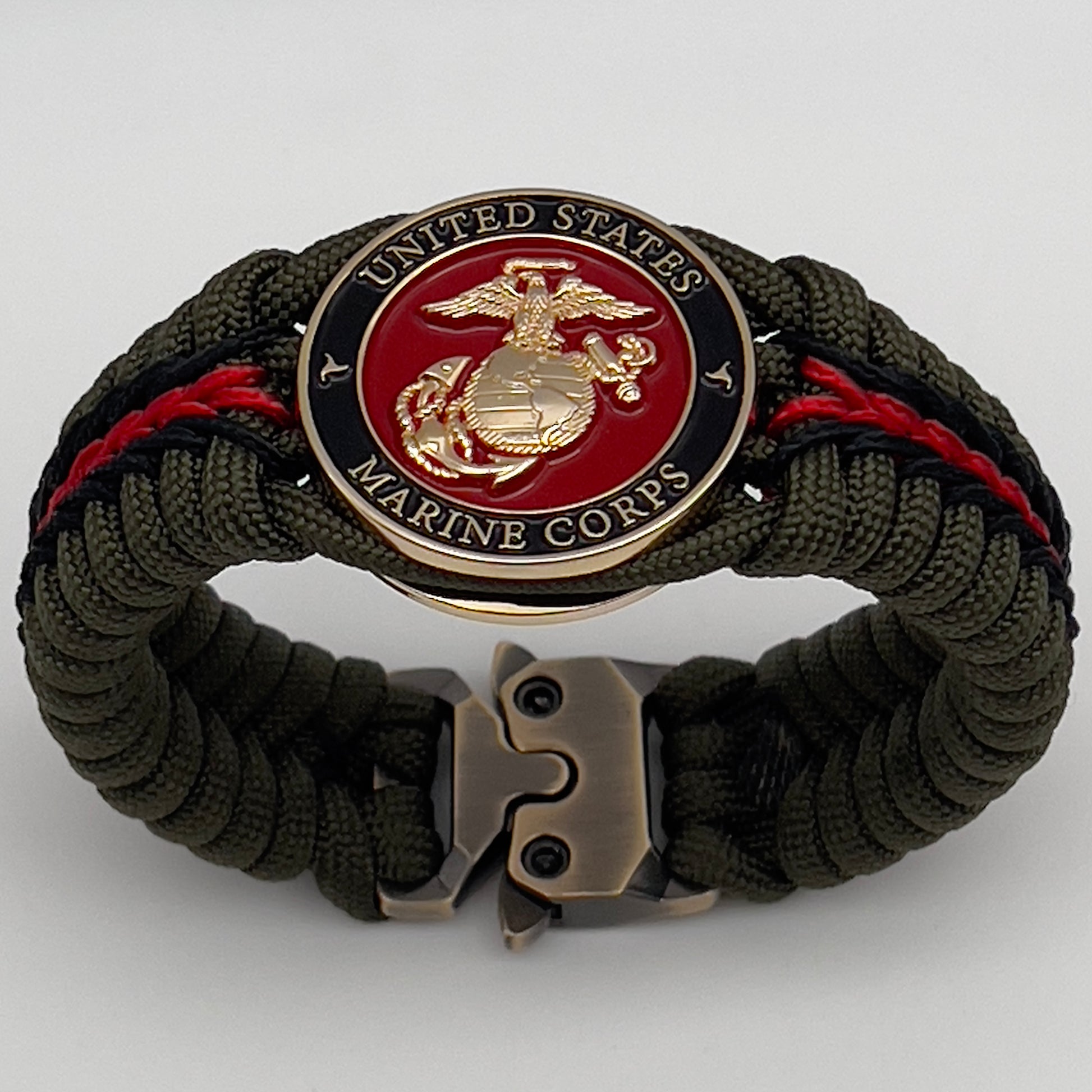 Thick, rigid and comfortable braided United States Marine Corps bracelet featuring a 24K gold plated USMC officer Eagle Globe and Anchor medallion, a gold Cobra style tactical buckle and woven with olive drab 550 paracord and black and Imperial red micro cord.