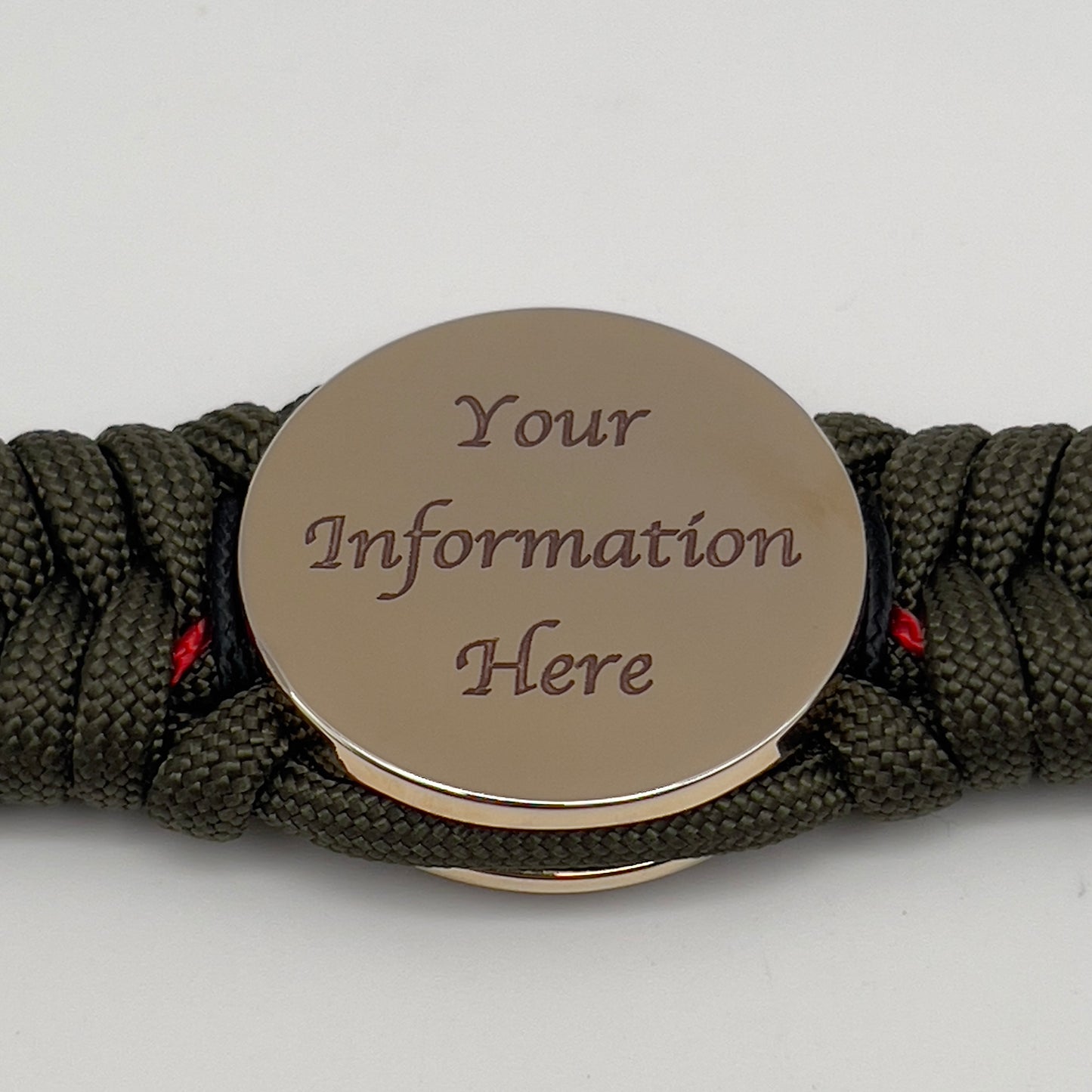 Thick, rigid and comfortable braided United States Marine Corps bracelet featuring a 24K gold plated USMC officer Eagle Globe and Anchor medallion, a gold Cobra style tactical buckle and woven with olive drab 550 paracord and black and Imperial red micro cord.