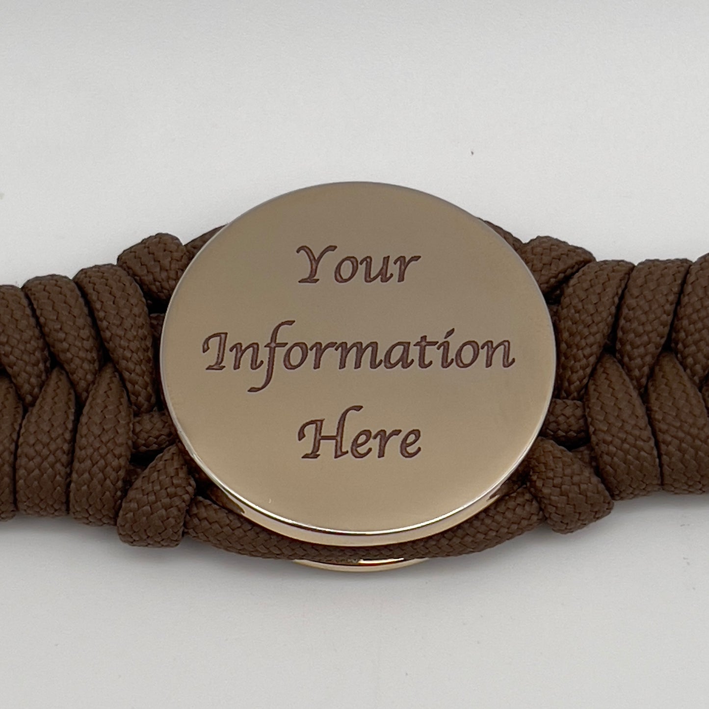 Thick, semi-rigid and comfortable braided United States Marine Corps bracelet featuring a 24K gold plated USMC Eagle Globe and Anchor medallion, a gold Cobra style tactical buckle and woven with Coyote Brown 550 paracord.